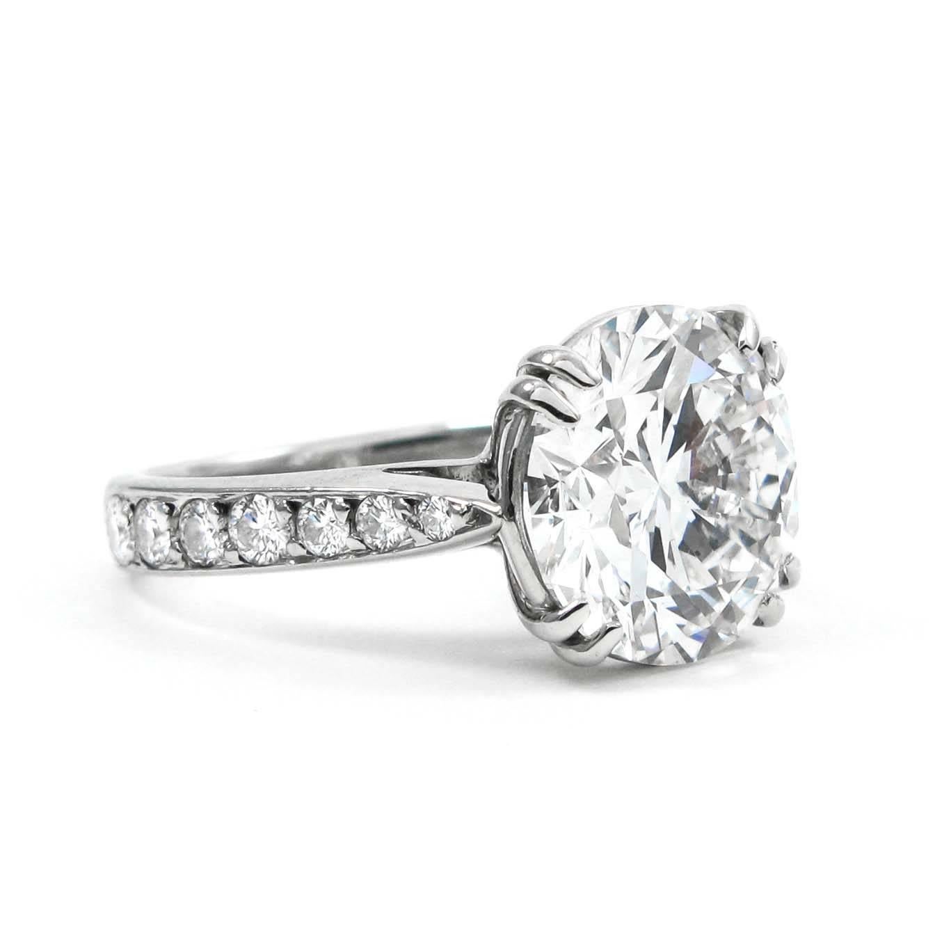 This stunning ring features a 2.51 carat round cut diamond as it's centerpiece, surrounded by a sparkling pavé setting in luxurious 18K white gold. 

The central diamond holds a fine example of craftsmanship, this D color diamond gleams with a