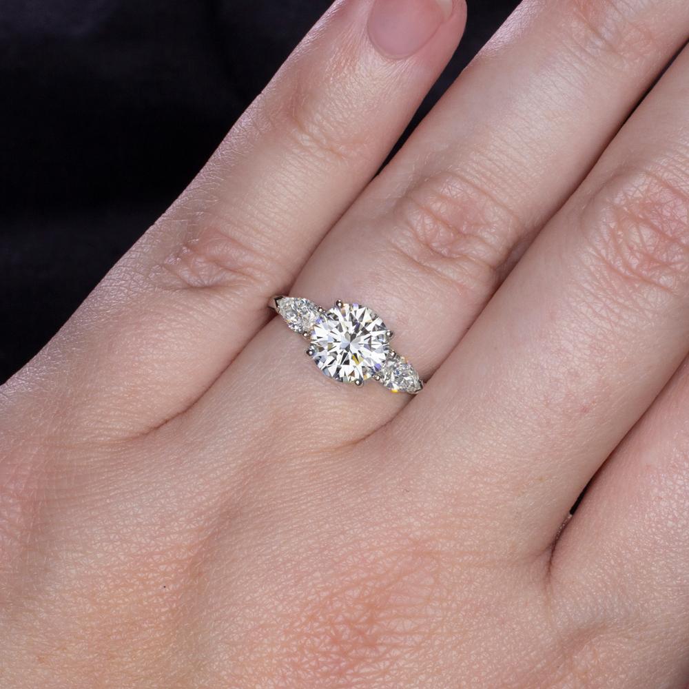 This engagement ring is a breathtaking example of refined craftsmanship and timeless beauty, designed to celebrate the most meaningful moments in life. At its heart is a dazzling 2 carat round cut diamond, certified by GIA for its exceptional