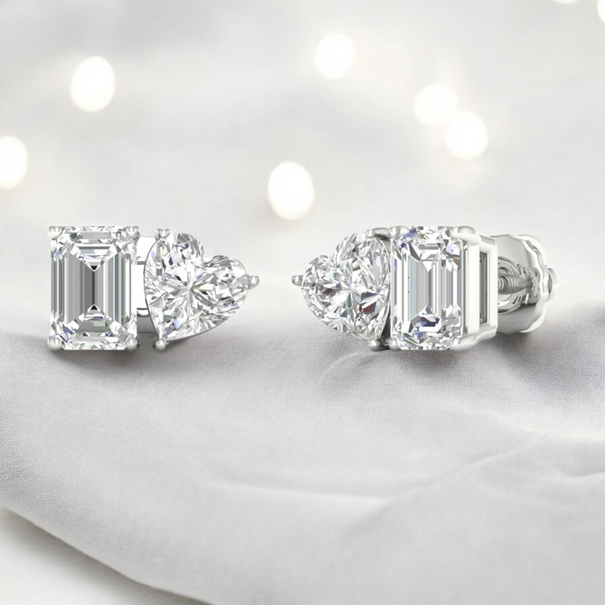 2 carats of stunning F/VS1 diamonds grace these exquisite toi et moi stud earrings, set in elegant 18K white gold. The emerald and heart cut diamonds are beautifully showcased in a solitaire setting, making them a perfect choice for special