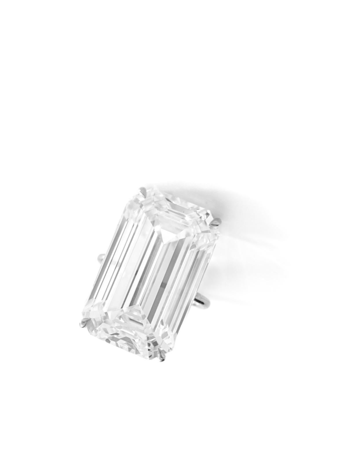 A masterpiece of timeless elegance, this estate diamond ring showcases a breathtaking GIA-certified 20-carat emerald-cut diamond. With its H color and VS1 clarity, this diamond radiates exceptional brilliance while maintaining a refined,