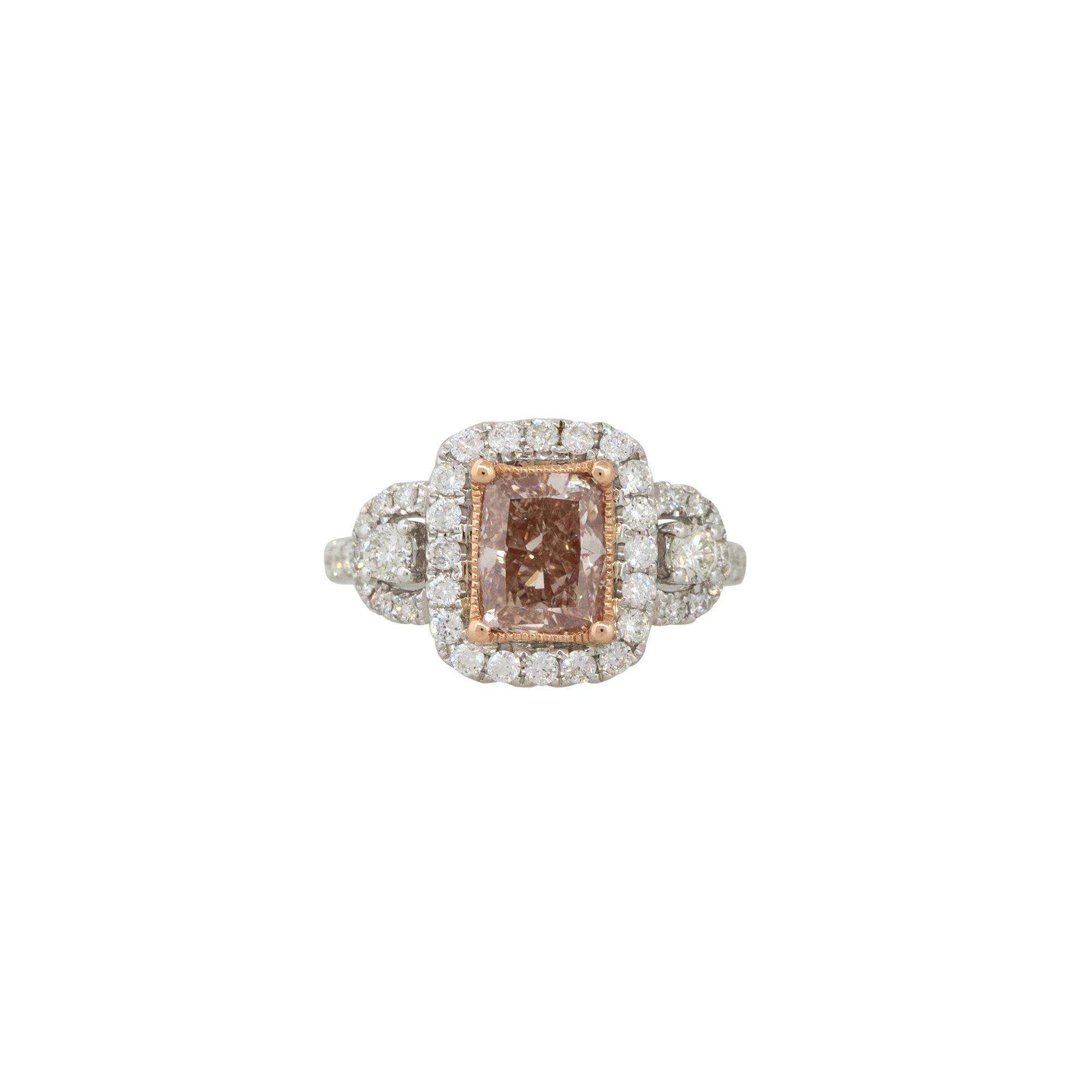 This GIA Certified 18k White Gold 2.0ctw Fancy Brown-Pink Diamond Ring is a stunning piece of jewelry that features a fancy brown-pink diamond center stone, surrounded by a halo of smaller white diamonds, set in a band made from 18k white gold.

The