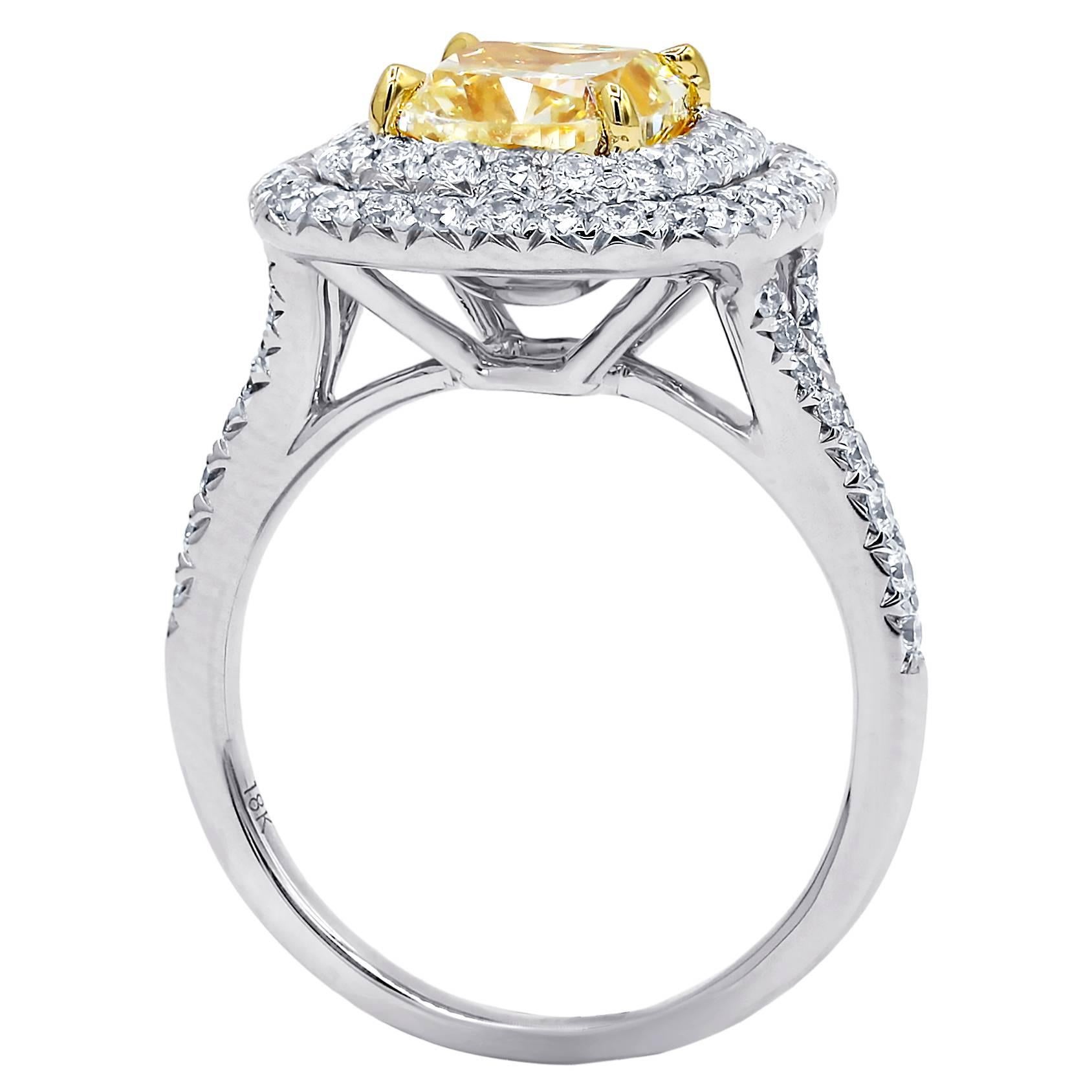 18 karat white gold diamond engagement ring with natural fancy yellow cushion modified brilliant cut diamond in the center,weighing 2.00 carats VS2 clarity set in beautiful double halo mounting and accented by 0.80 carats total round cut diamonds on