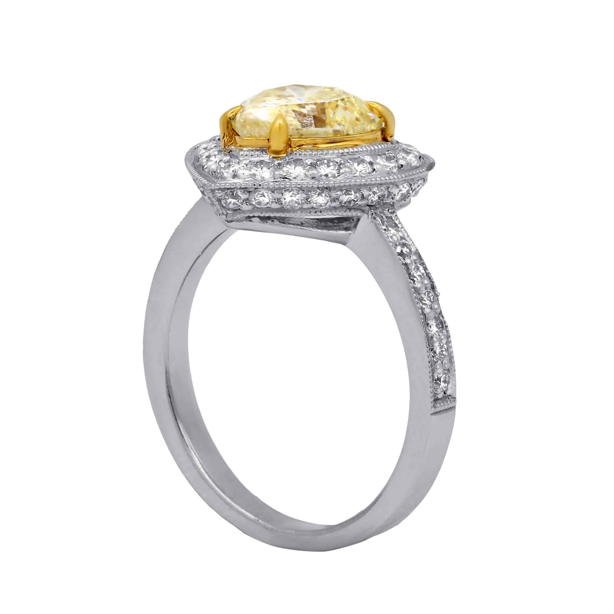 Exceptional   diamond engagement ring in 18 karat white gold mounting. 
The main GIA certified stone features natural fancy yellow heart brilliant cut ,weighing 2.00 cts  set in halo setting and enhanced by 1.00 cts total round cut diamonds.

•