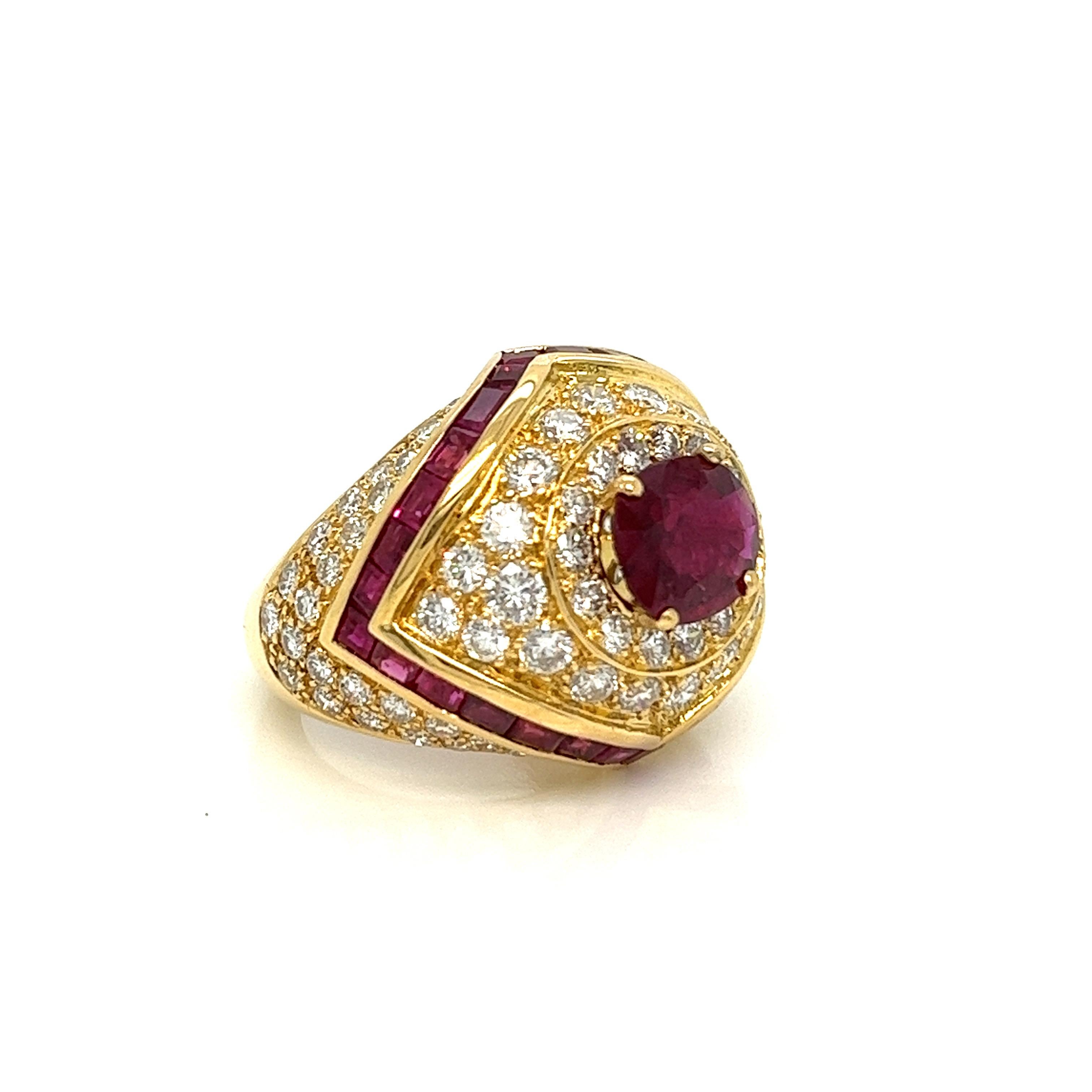 One of the most fabulous, chunky cocktail rings we’ve recently laid our eyes on! In the most gorgeous 18 karat buttery gold setting, this 2.00 ct. oval cut Thai heated ruby, certified by GIA, sits front and center. It's surrounded by inlaid round