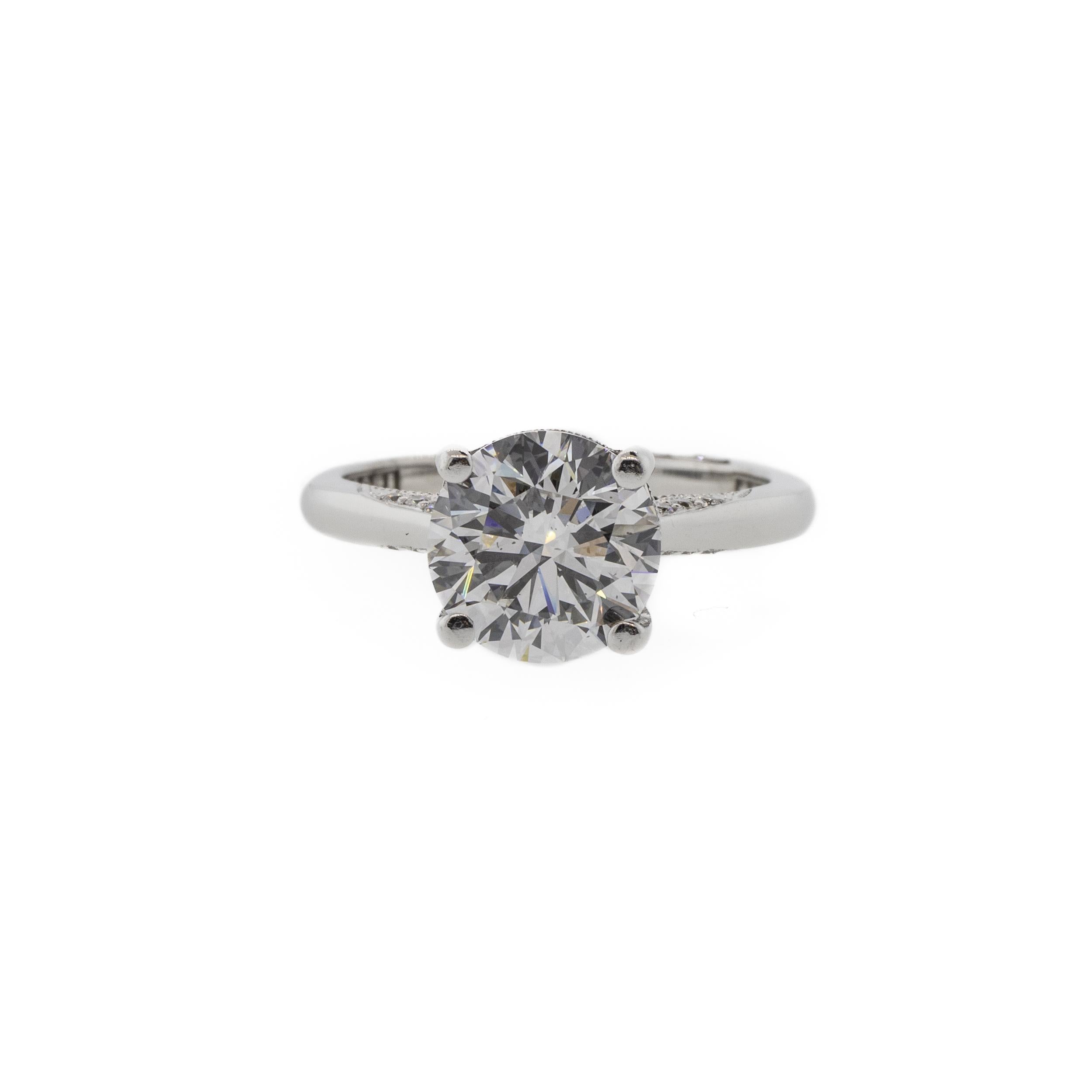 A perfectly classic Tacori solitaire engagement ring in an elegant four prong setting. Featuring a GIA certified 2.02ct D/VS2 round brilliant cut diamond. The 18K white gold band has lovely milgrain details along the top and bottom of the shoulders.
