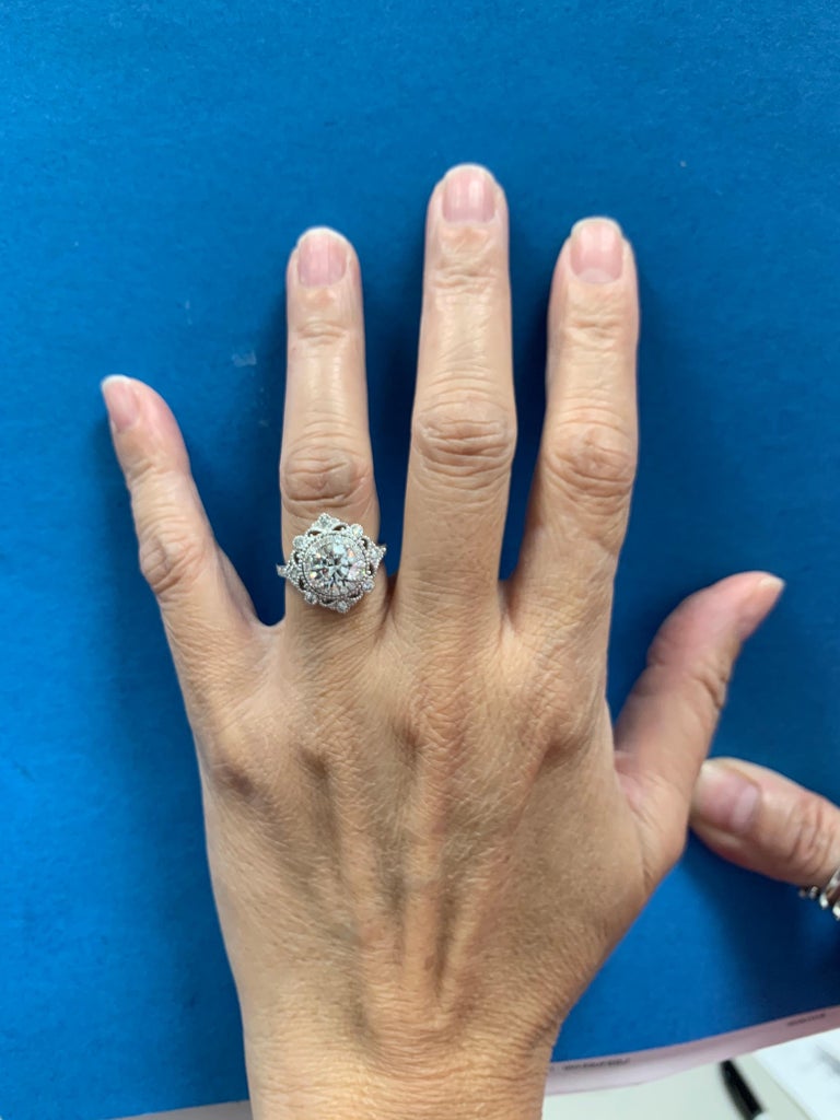 A stunning antique reproduction ring set in 18K white gold. The ring is set with 42 natural round brilliant diamonds weighing 0.60 carats and are F in color and VS in clarity. 

Set in the center is a 2.01 carat GIA certified natural round brilliant