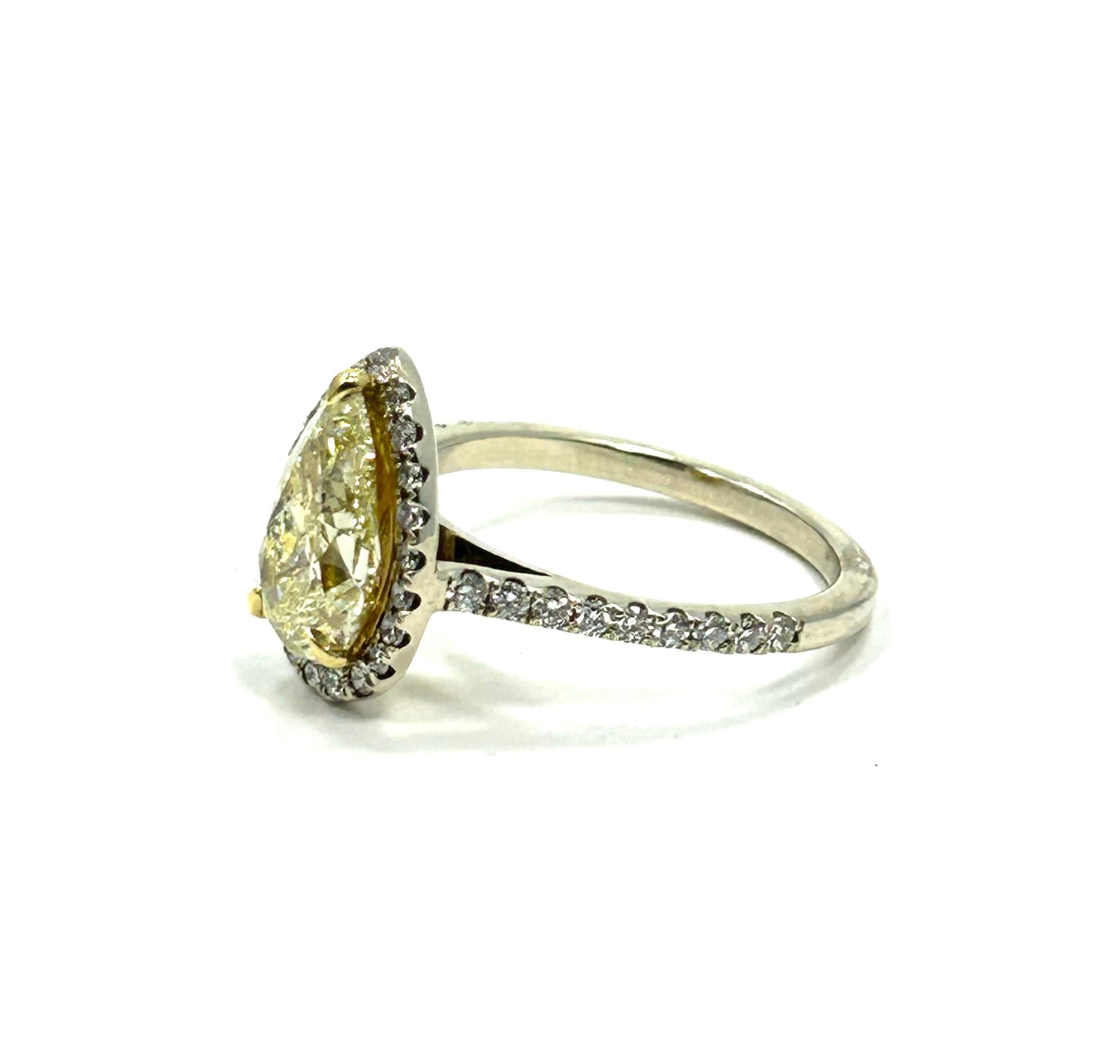 Hi how are you? Welcome to Prince Estate Jewelry. Today we are sharing with you a beautiful light fancy yellow pear cut diamond engagement ring. The 2.01ct. is surrounded by 22 stunning round brilliant cut diamonds and supported by 18 round