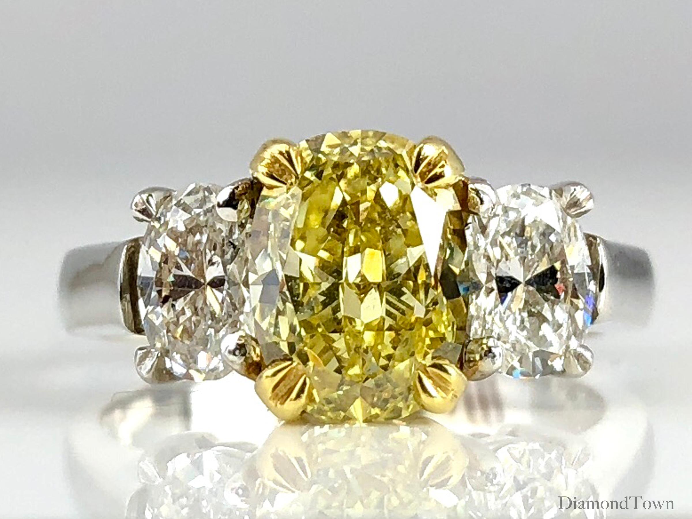 Indulge in luxury and sophistication with this breathtaking ring that epitomizes elegance and grace. At its heart lies a dazzling GIA Certified 2.01 Carat Natural Fancy Intense Yellow Oval Cut diamond, exuding unparalleled brilliance and allure.
