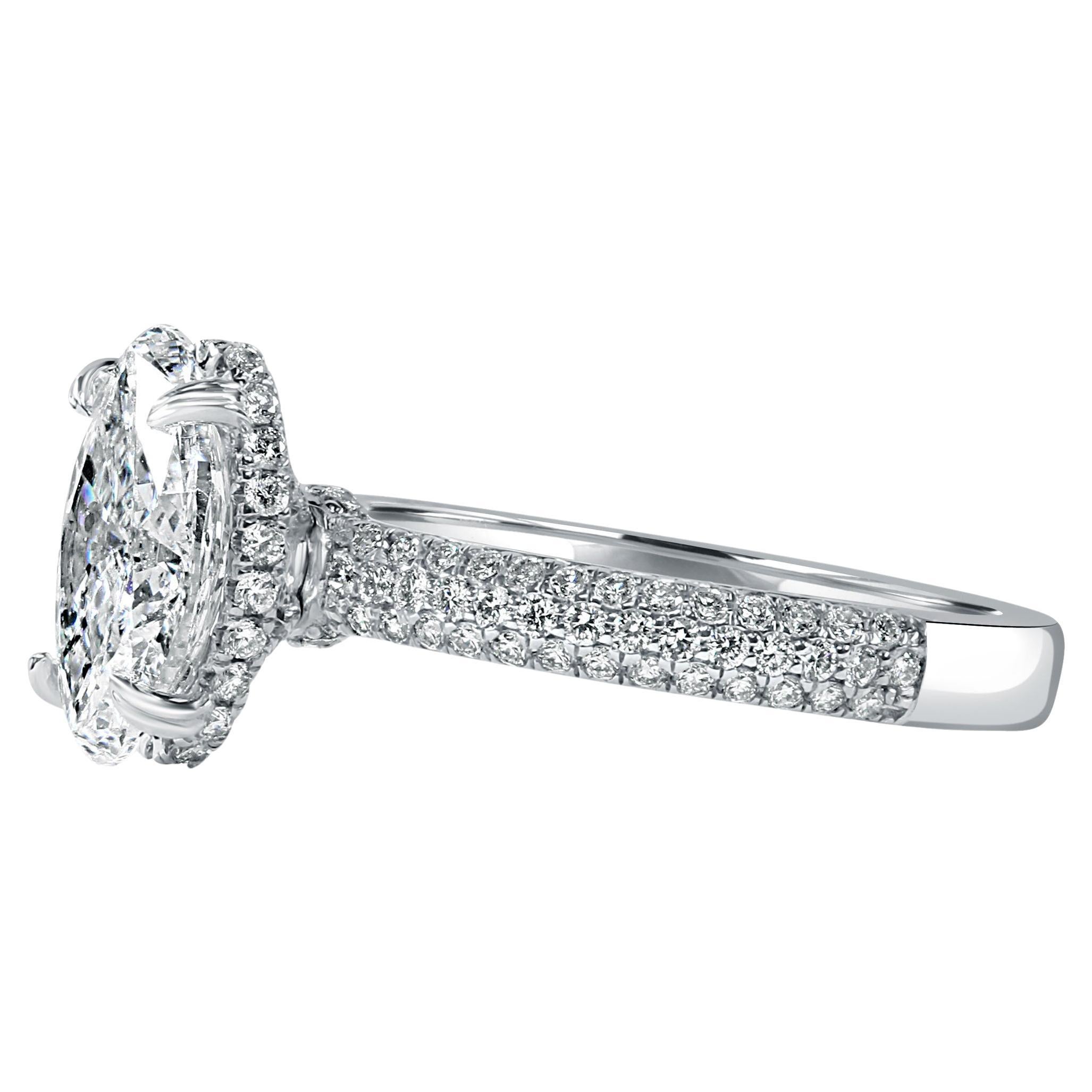 This dazzling diamond engagement ring showcases a stunning 2.01-carat GIA certified oval brilliant cut center diamond, radiating with F color and I2 clarity. The center diamond is elegantly prong set atop a sleek 18-karat white gold shank, creating