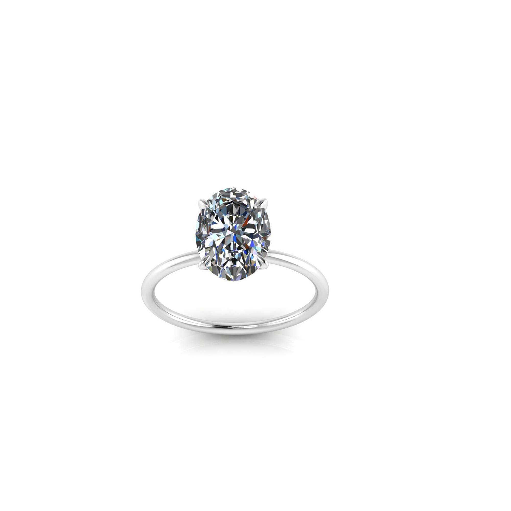 GIA Certified 2.01 carat Oval diamond, F color, VS1 clarity, Triple Excellent specs for a maximum brightness.
Set in a low, thin Platinum 950 setting, minimalist and fine, to enhance the diamond.

The ring is Size 5.75, we offer complimentary sizing