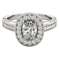 Anello con diamante ovale aureolato inciso e traforato certificato GIA da 2.01 carati