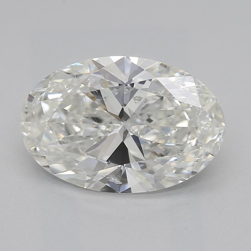 Handcrafted in New York, this exquisite diamond ring is a remarkable testament to elegance and craftsmanship, featuring a breathtaking oval H SI2 2.01 center stone. Set in luxurious white gold , the design is a harmonious blend of classic