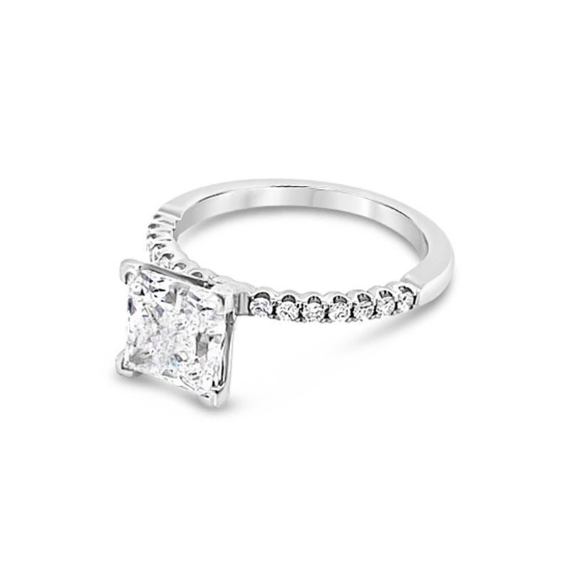 This beautiful engagement ring features a 2.01 carat princess cut diamond, F SI1, set in 14 karat white gold and accented with 0.22 carat total weight in round diamonds halfway down the band. This ring is currently a size 5.5 but can be resized upon