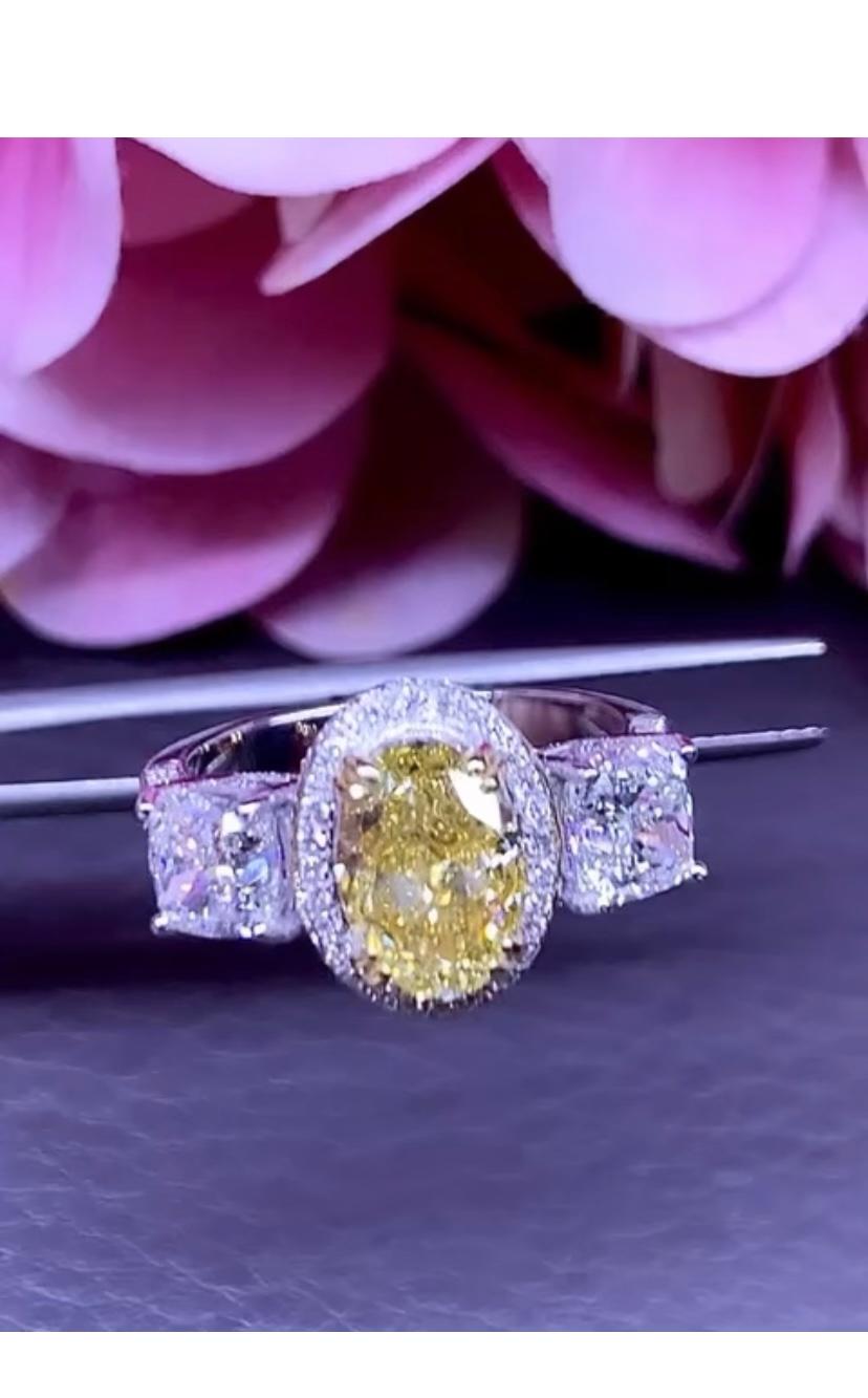 An exquisite ring in contemporary design, so modern and particular style.
Ring come in 18k with a GIA certified 2,01 carats of Fancy Brownish Yellow Diamond in oval cut. 
VS1 clarity, and two pieces of GIA certified
 1,00 + 1,00 carats, I/VS1-VS2,