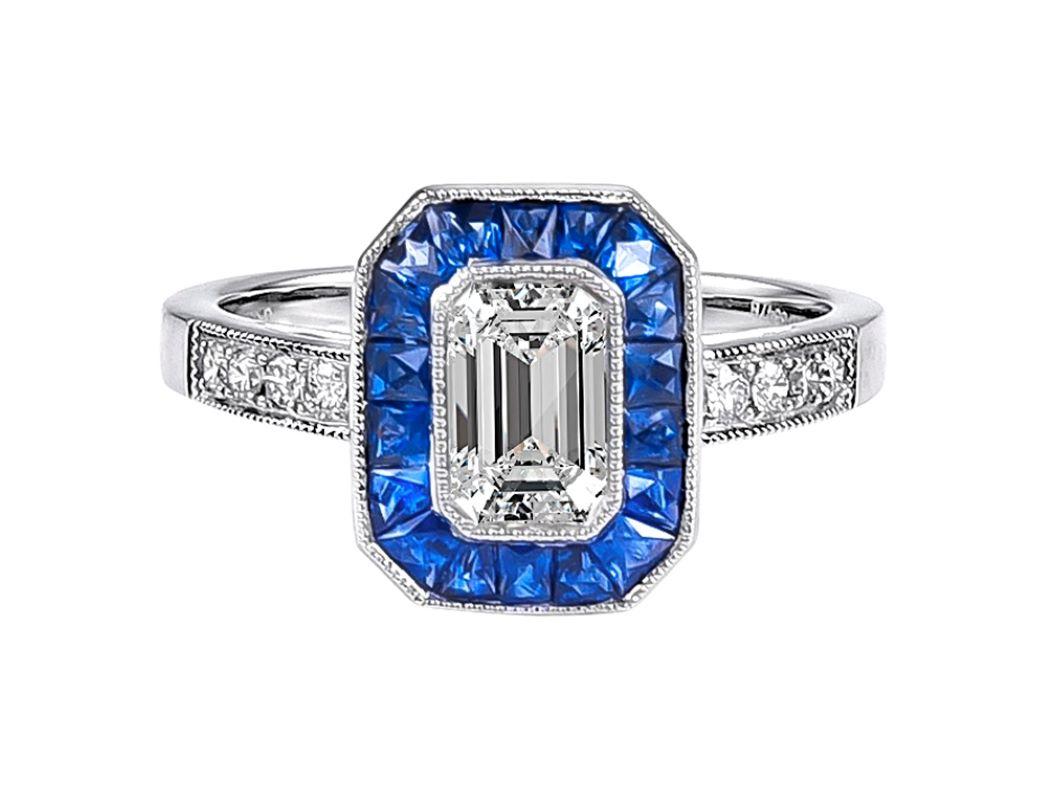 This elegant platinum ring contains a GIA certified 2.01 emerald cut diamond center stone with a color and clarity of F-VS2 surrounded by sapphire weighing 1.05 carats and small diamonds weighing a total carat weight of 0.23 carats.

Ring is