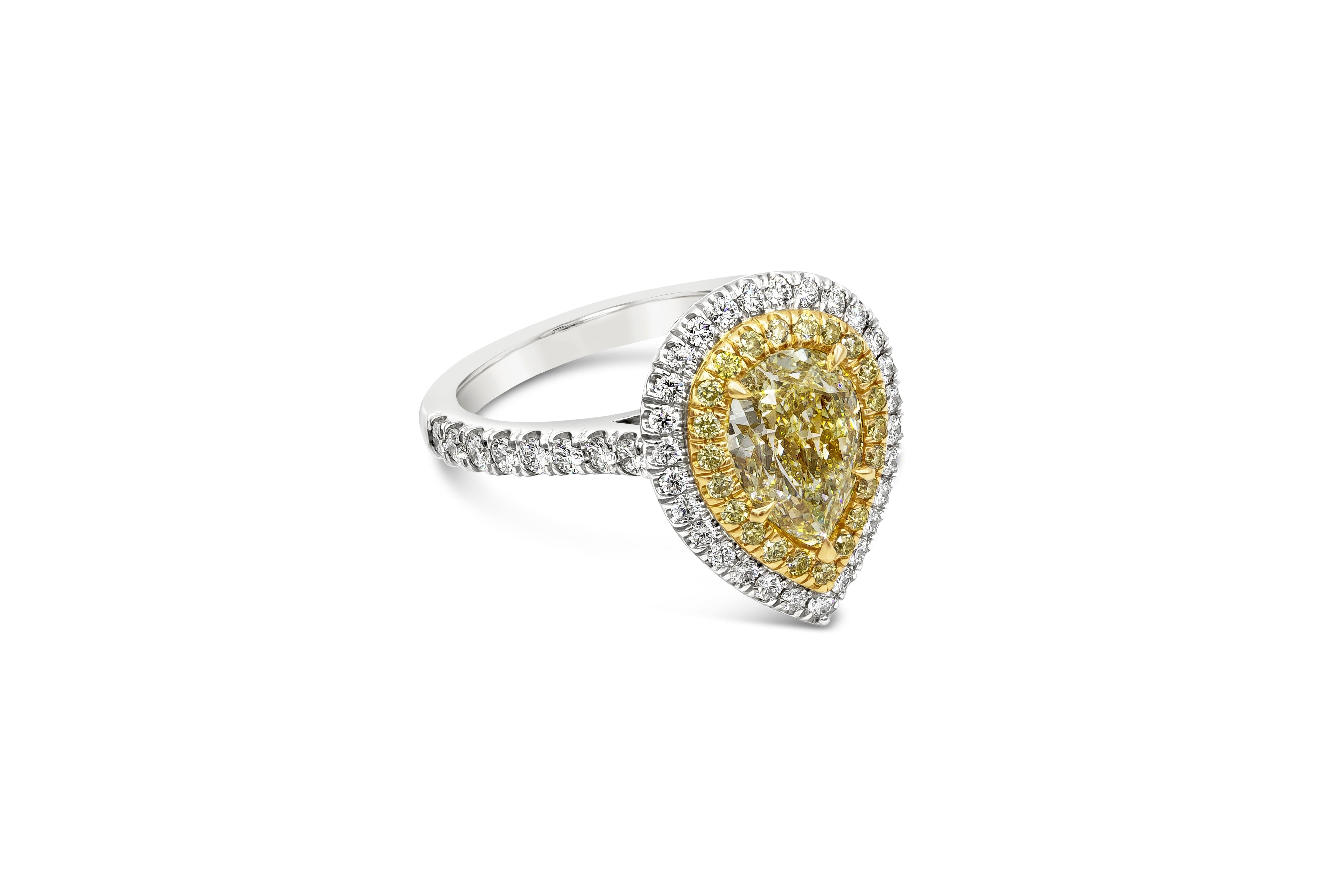 Ein brillanter Verlobungsring mit einem farbenprächtigen gelben Diamanten in Birnenform mit einem Gewicht von 2,01 Karat, zertifiziert von GIA als Fancy Light Yellow, VS1 clarity. Um den zentralen Diamanten herum befinden sich zwei Reihen runder