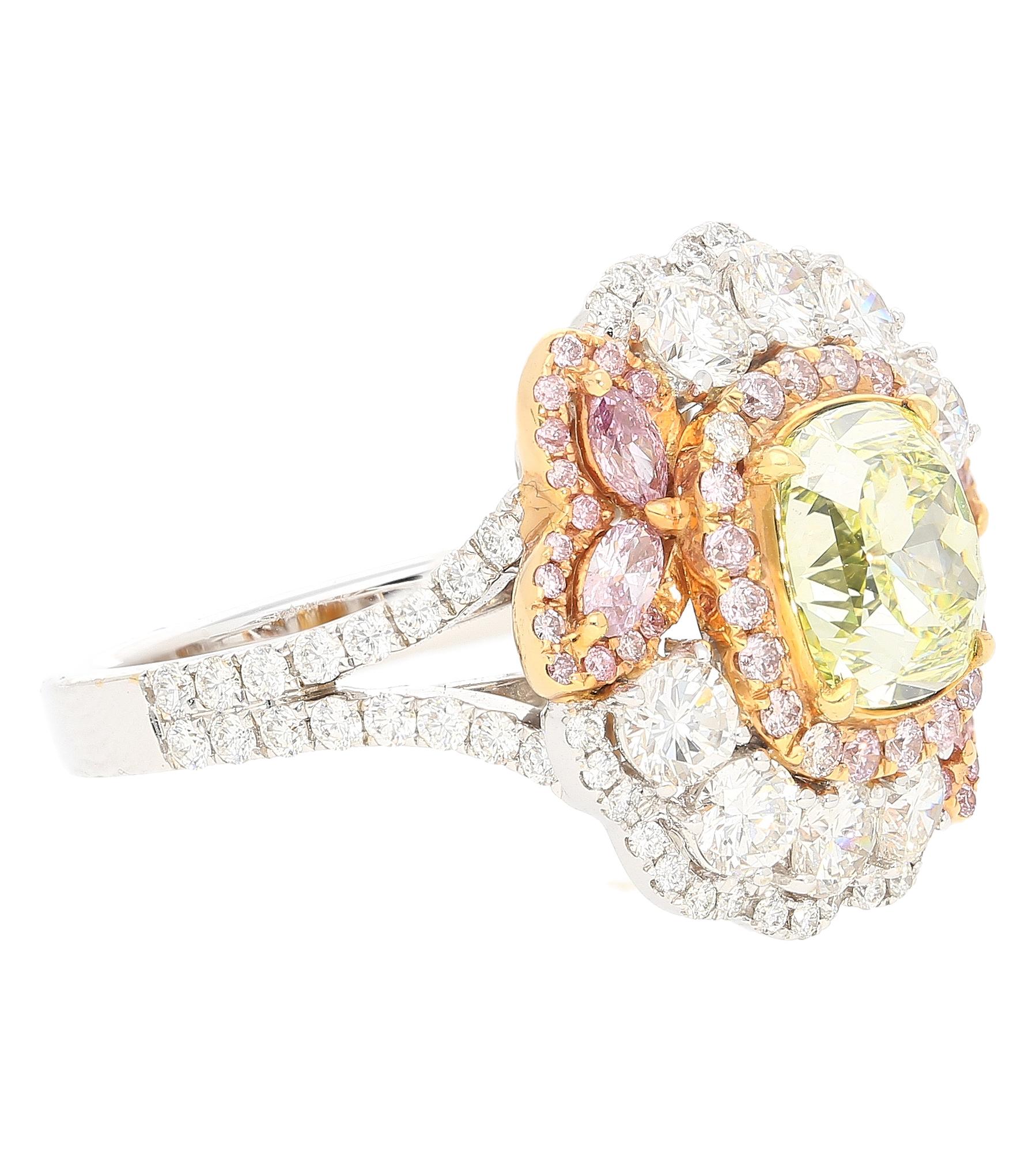 GIA Certified 2.02 Carat Cushion Cut Fancy Greenish Yellow Diamond Ring. Set with a colorful array of mixed-cut pink and white diamonds. This ring is a glowing piece of top-quality natural diamonds from around the world. Set in 18k white gold with
