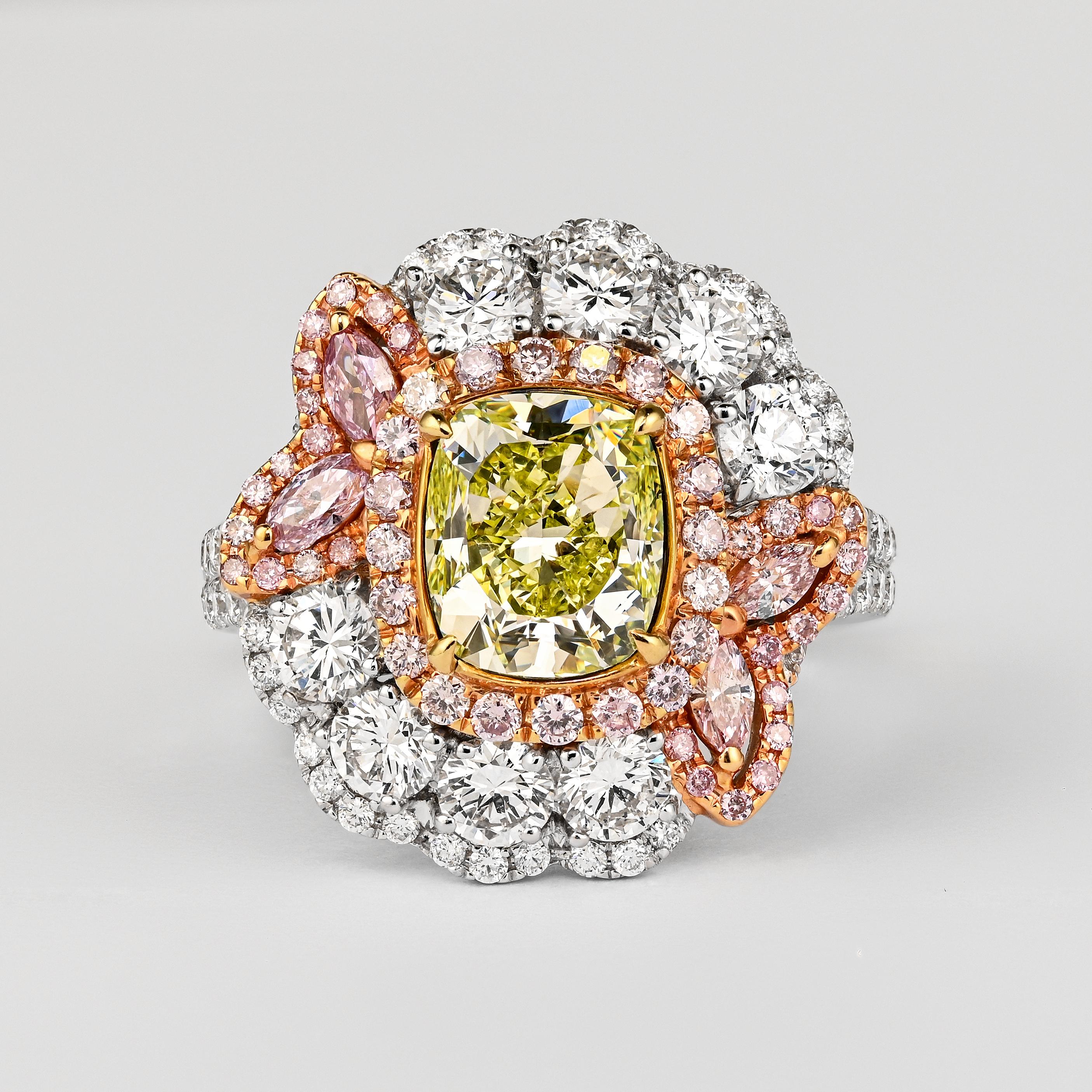 GIA Certified 2.02 Carat Cushion Cut Fancy Greenish Yellow Diamond Ring. Set with a colorful array of mixed-cut pink and white diamonds. This ring is a glowing piece of top-quality natural diamonds from around the world. Set in 18k white gold with