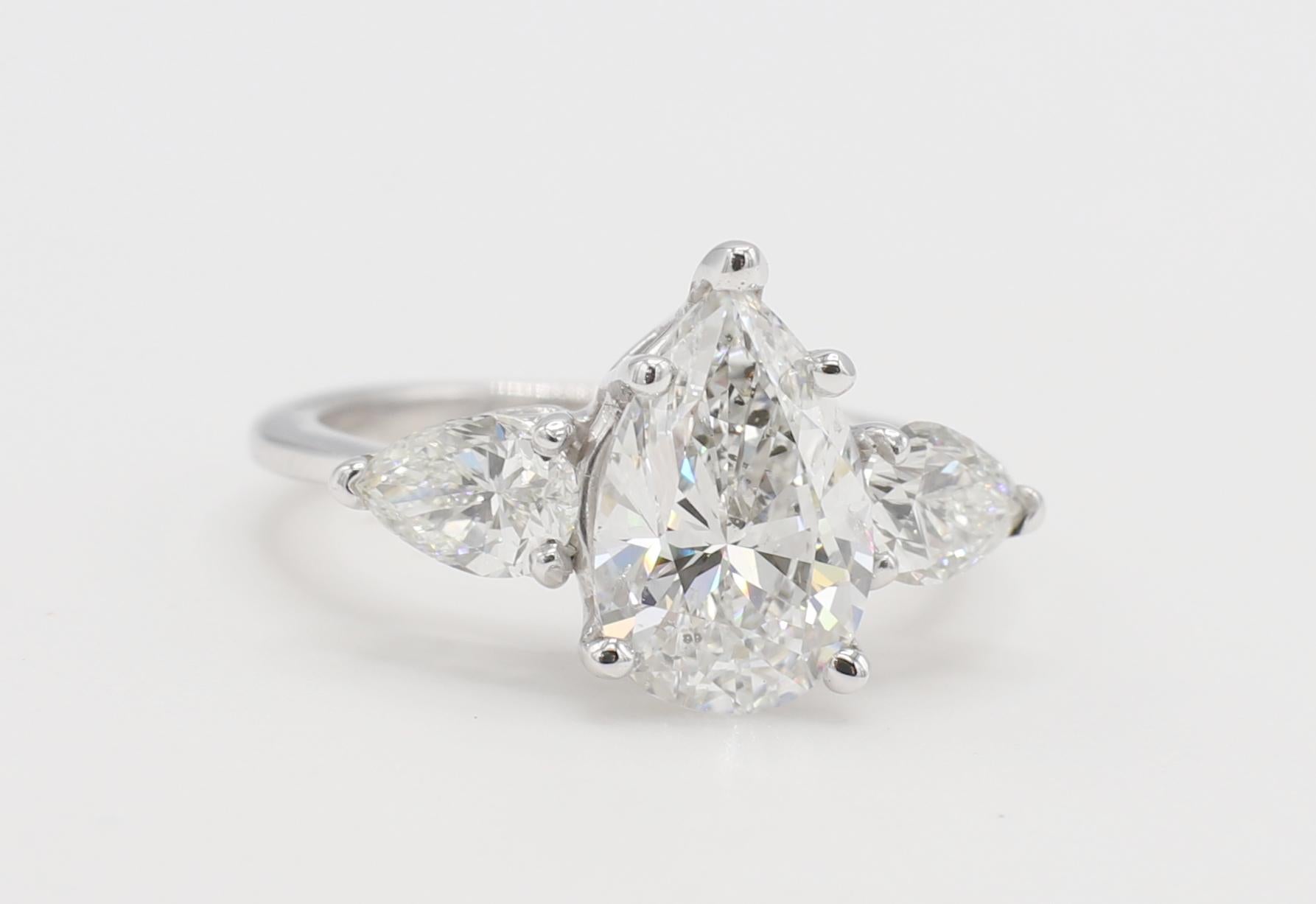 Modern GIA Certified 2.02 Carat F SI2 Pear Shape Diamond Three Stone Engagement Ring