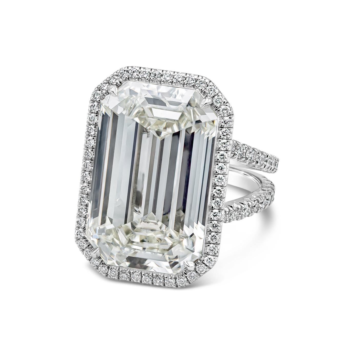 A special and well-crafted ring by Roman Malakov Diamonds featuring a 20.21 carat emerald cut diamond, accented by a thin diamond halo. Set in an intricate design split-shank mounting made in platinum. Accent diamonds weigh 1.10 carats total.