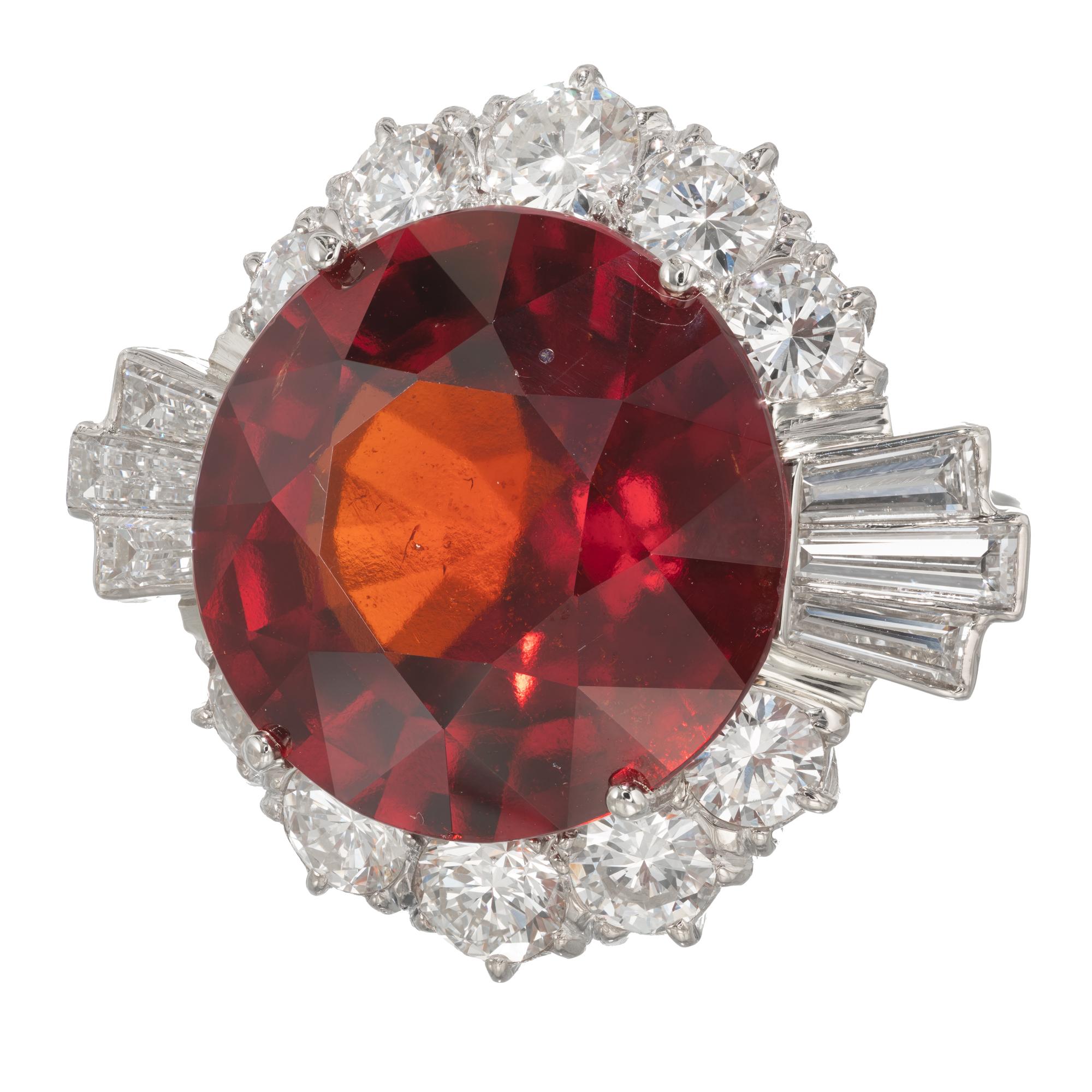 1950's GIA certified natural 20.28ct round reddish orange Hessonite Garnet iand diamond halo cocktail ring. 18k white gold setting with a halo of  round and baguette diamonds. 

1 round reddish orange Hessonite Garnet, approx. total weight 20.28cts,