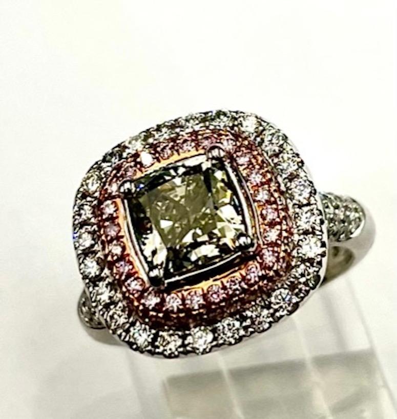 This ring boasts a unique natural color combination that is both alluring and bright. The inner halo is comprised of natural pink color diamonds followed by an outer halo of natural white diamonds. The SI1 clarity grading is located completely at