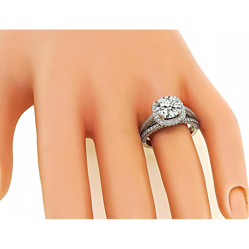 This is an elegant 14k white gold engagement ring and wedding band set. The engagement ring is centered with a sparkling GIA certified round cut diamond that weighs 2.02ct. The color of the diamond is I with I1 clarity. The center diamond and the