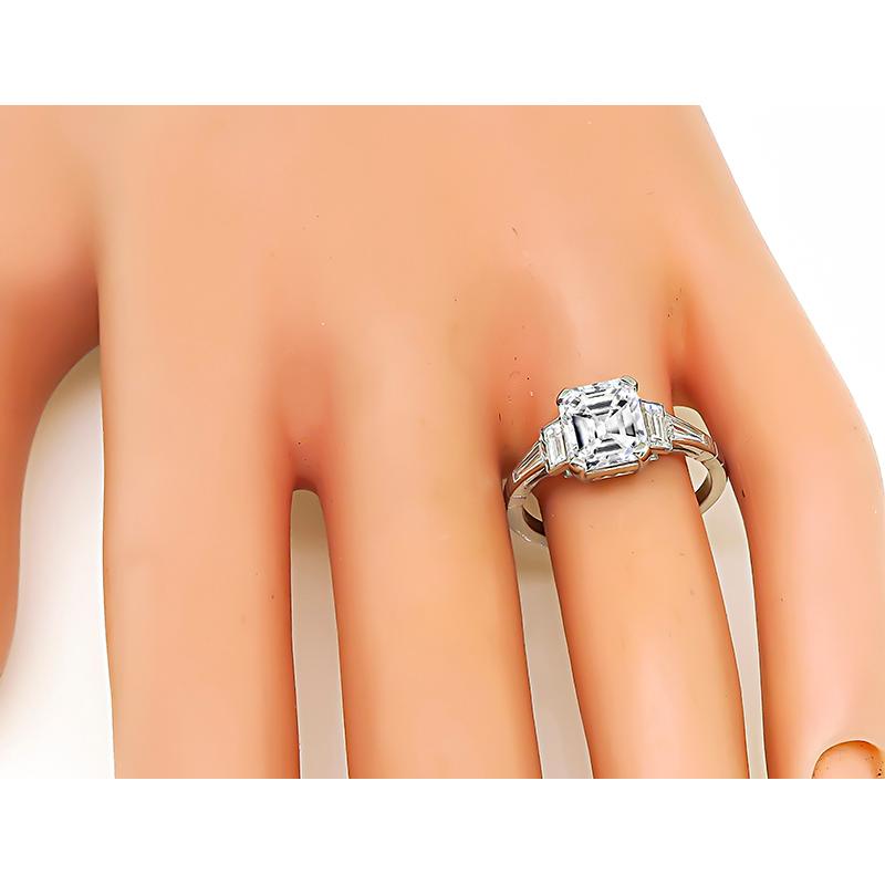 This is a gorgeous platinum engagement ring. The ring is centered with a sparkling GIA certified emerald cut diamond that weighs 2.02ct. The color of the diamond is F with VVS2 clarity. The center diamond is accentuated by baguette and emerald cut