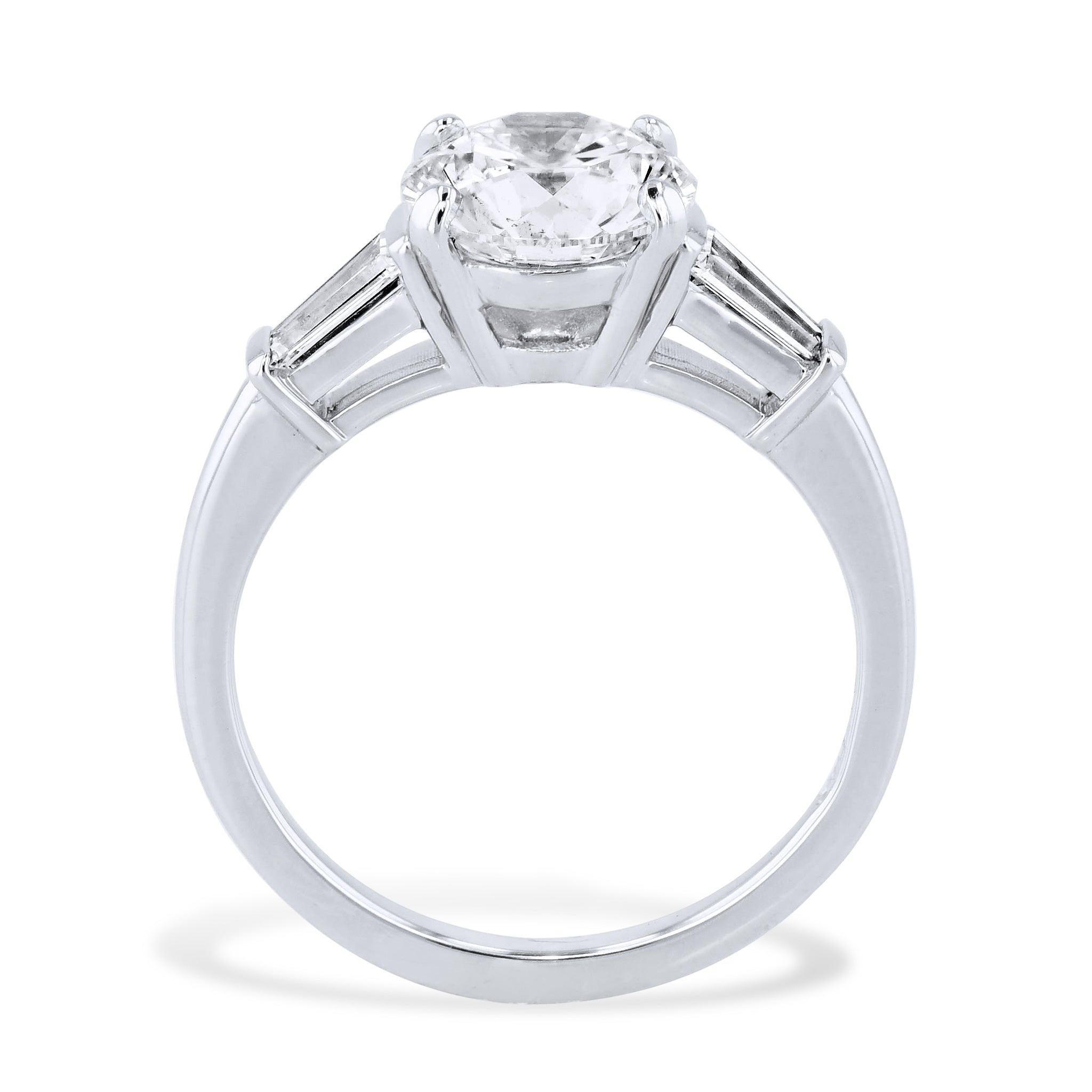 The exquisite Round Diamond Platinum Engagement Ring features a 2.03 carat Round Brilliant Cut Diamond. 
GIA #6167102559. Sleek tapered baguettes complete the majestic design.

Round Diamond Platinum Engagement Ring.
Platinum.
Center Diamond: