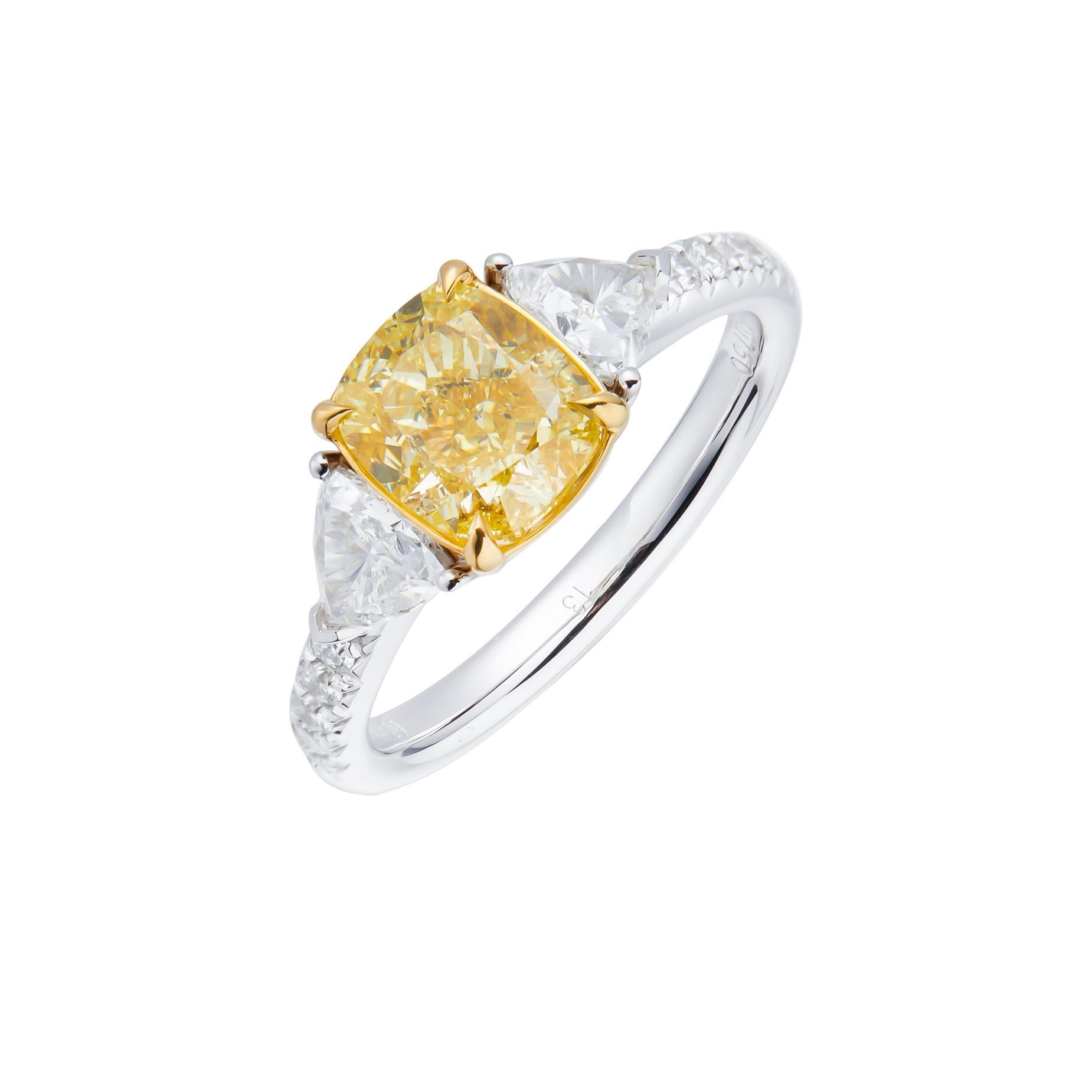 Elevate your jewelry collection with a true marvel of nature's artistry – a GIA certified 2.03 carat fancy light yellow cushion cut natural diamond. Set against the backdrop of a luxurious 18kt gold band, this exquisite piece exudes a sense of