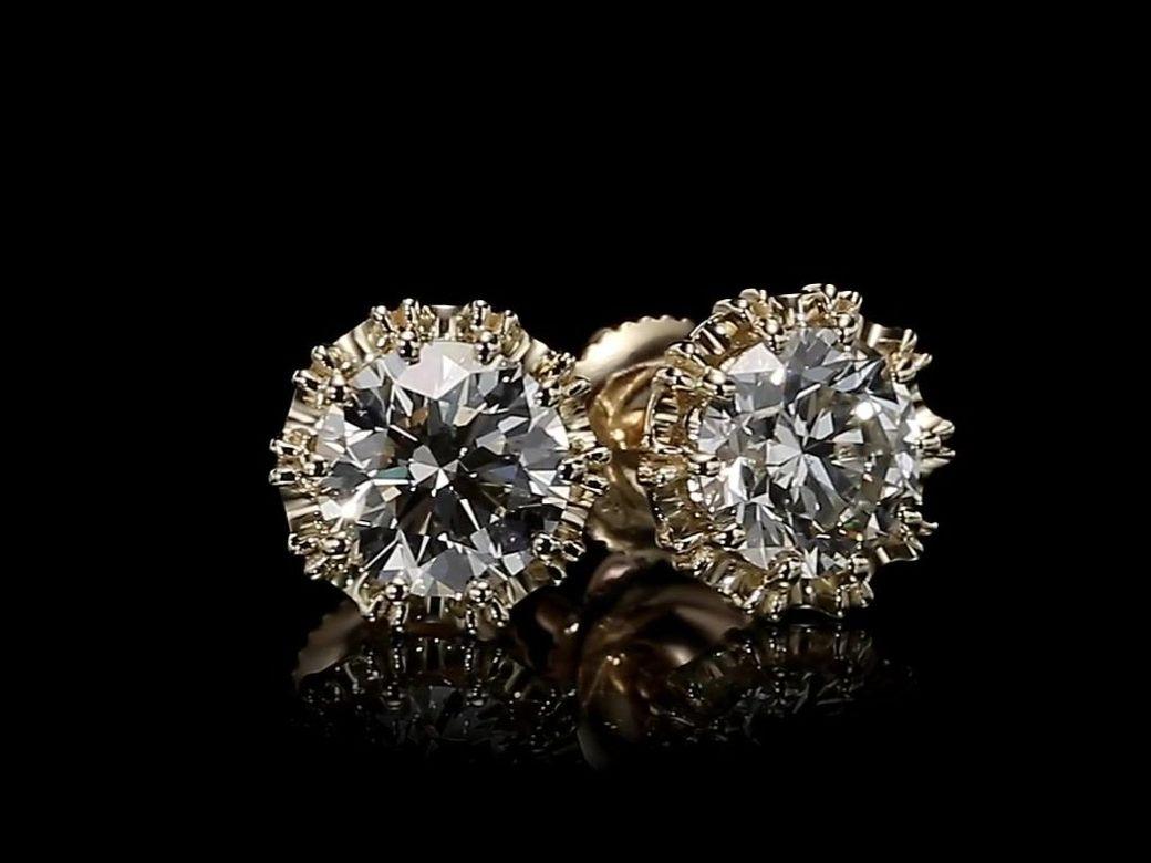 Our handcrafted 2.04 Carat total weight diamond earrings studs are made with detailed craftsmanship and set with two GIA certified 2.04 Carat Total Diamond Weight studs K / SI1 & K/ SI2. The timeless diamond studs are encircled and mounted on 18K