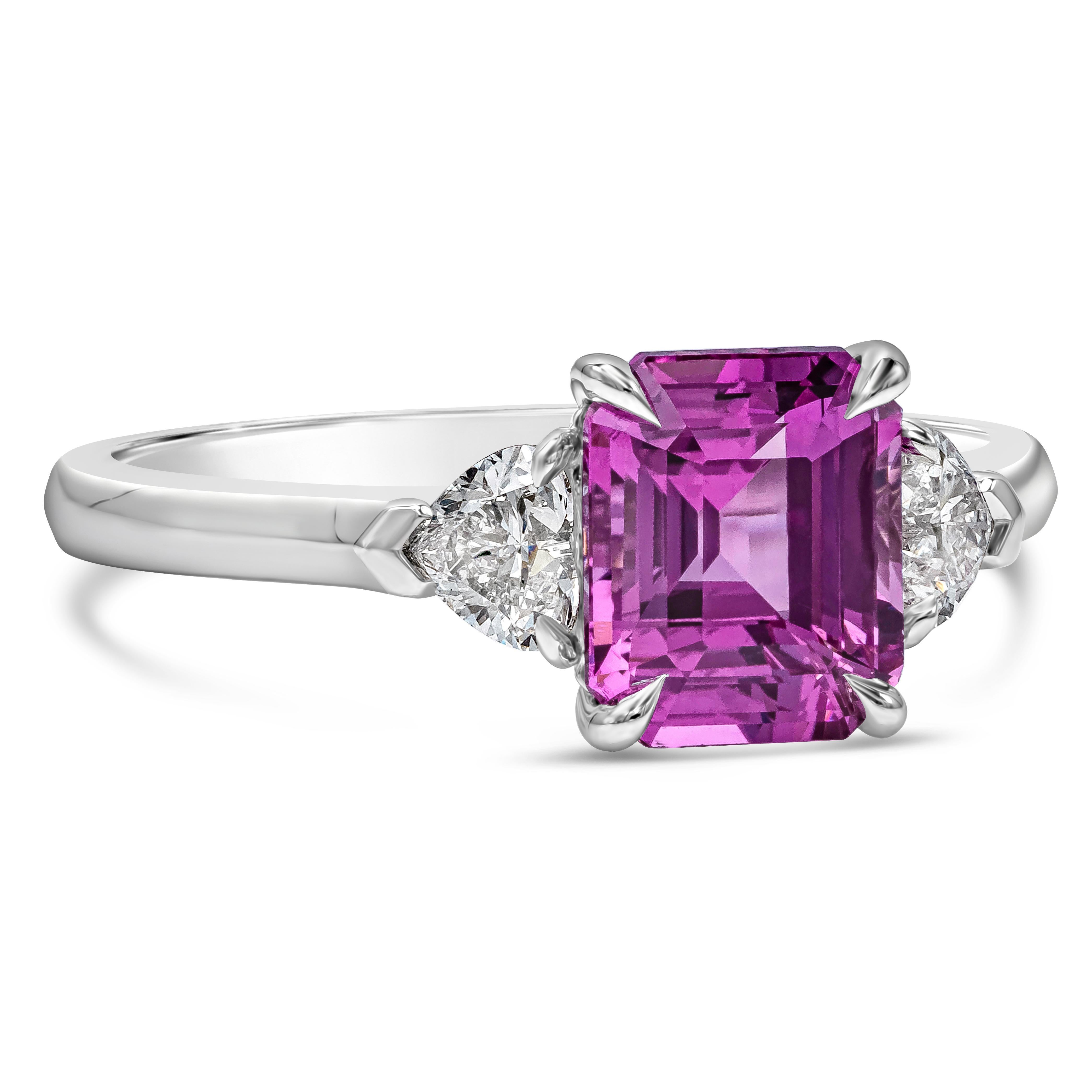 A color rich engagement ring style showcasing a GIA Certified Purple Pink Sapphire weighing 2.04 carat center stone, Madagascar origin. Flanked on each side by heart shape diamonds weighing 0.39 carats total, G Color and VS-Si in Clarity. Made in