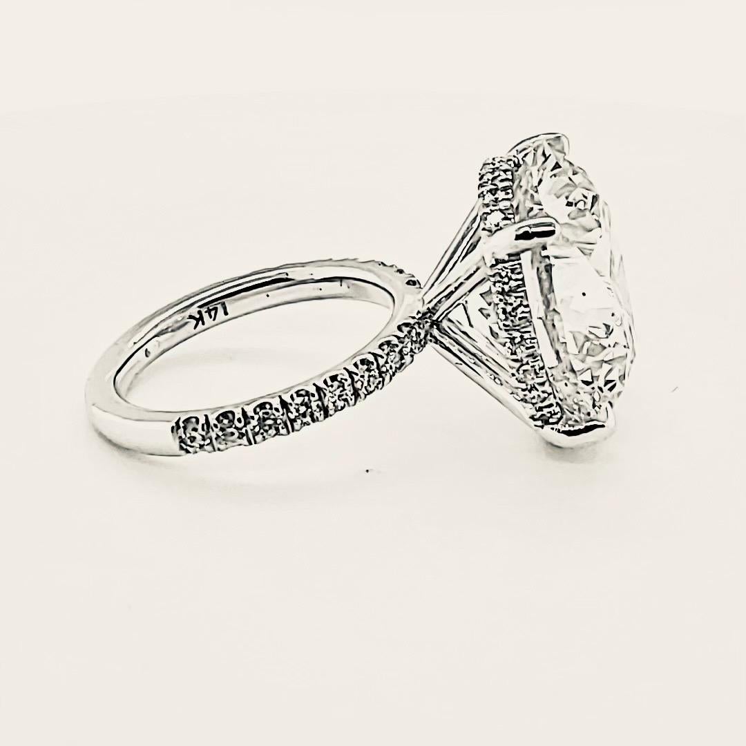 20.48 carat Round Brilliant cut diamond set on a 14Kt Kt White gold engagement ring with 44 diamond set on the under halo and on both sides of the band.totaling 0.53 carat .The center diamond has a 