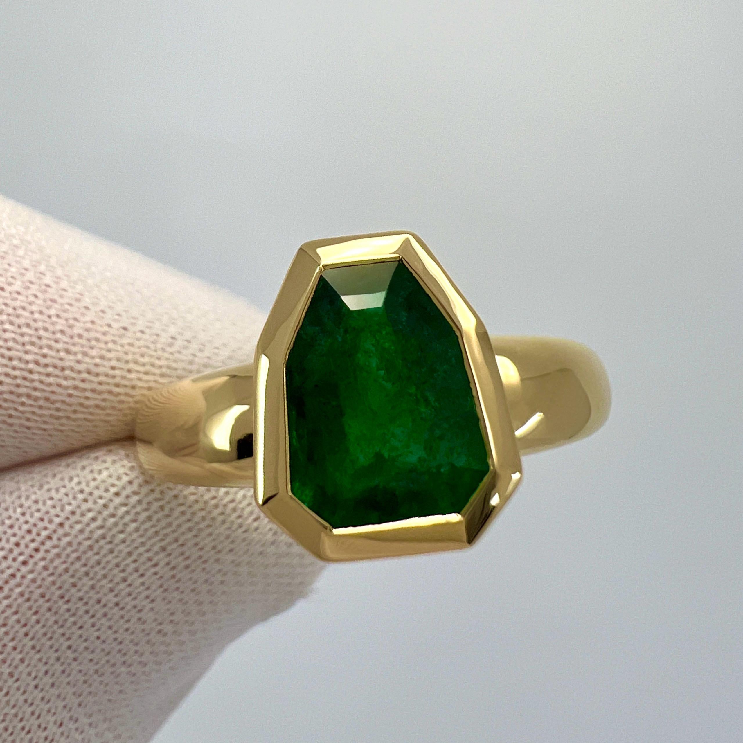Fine Deep Green Shield Cut Natural Emerald 18k Yellow Solitaire Bezel Rubover Ring.

GIA Certified 2.04 carat emerald with a stunning deep green colour and good clarity. Some small natural inclusions when looking closely at some angles, as to be