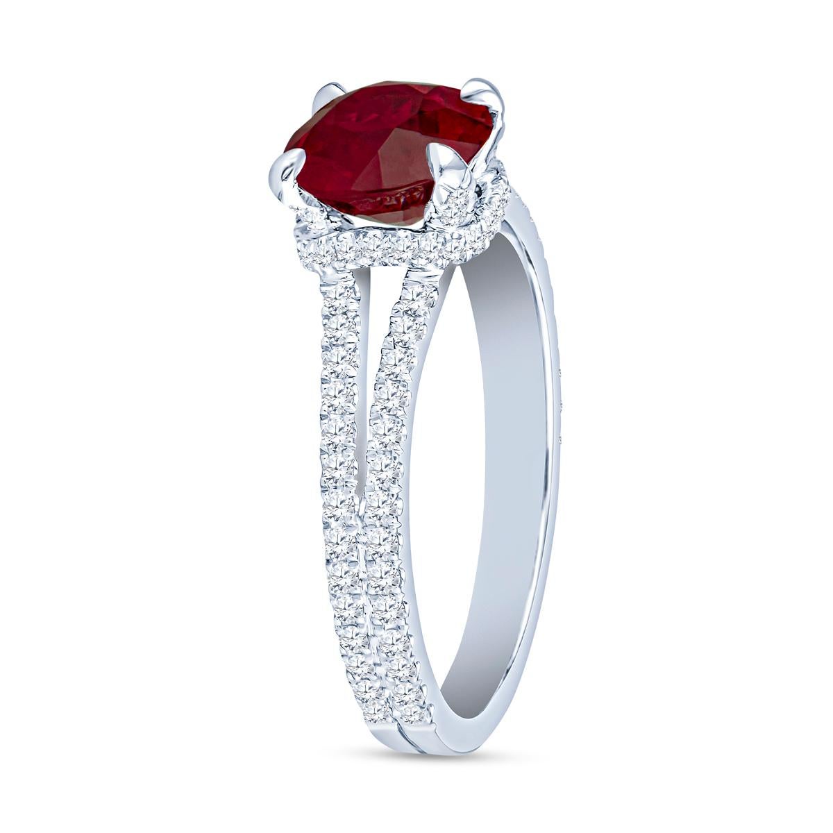 This exquisite ring features a 2.05 carat pigeon blood round ruby, beautifully set in luxurious platinum. The elegant split shank design is enhanced by sparkling diamonds, making it a perfect statement piece for any occasion. This ring is a size