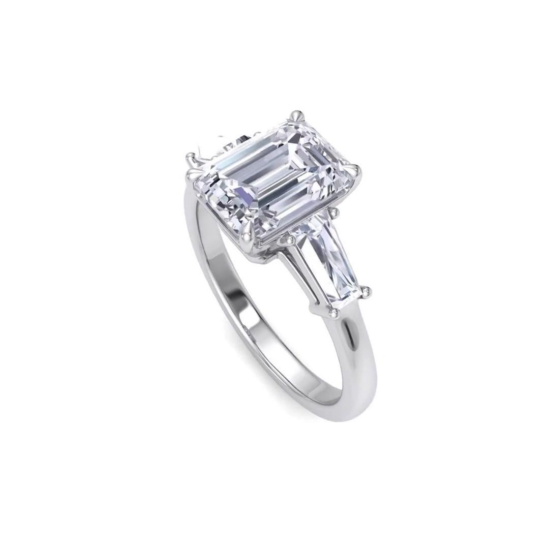 Notre bague de fiançailles artisanale intemporelle est ornée d'un diamant taille émeraude de 2,05 carats certifié par le GIA (G--H / VS2-VS1)
et accompagné de deux diamants taille baguette de 0,50 carat TDW G/ VS. Les diamants sont montés sur de