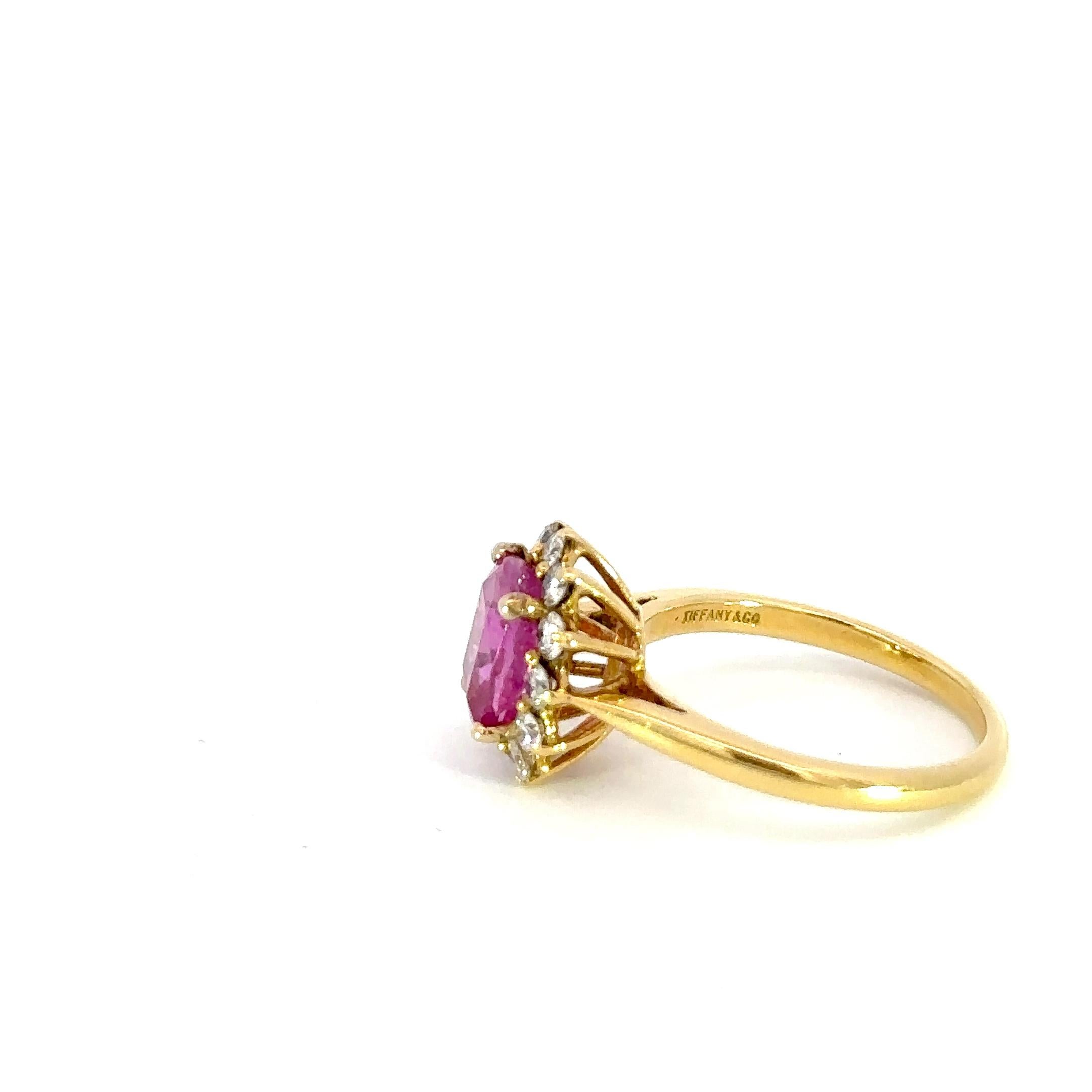 This exquisite ring features a brilliant 2.06 carat pink sapphire at its center, which has been certified by the GIA for its quality and authenticity. The pink sapphire is surrounded by a delicate rosette of sparkling white diamonds, enhancing its