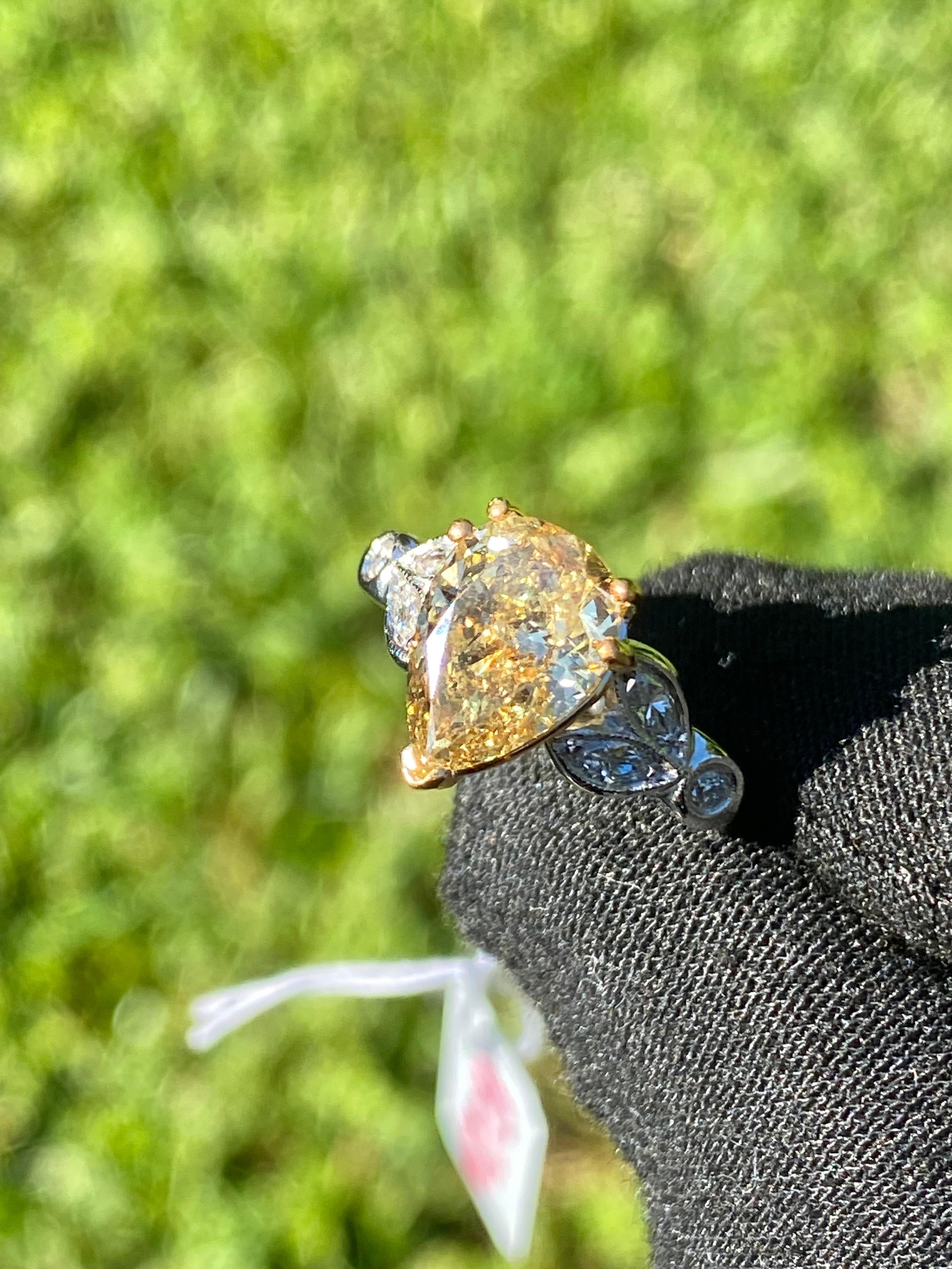 Centering a 2.07 Carat Pear-Shape Fancy Brownish Yellow Diamond. 

Ring Details: 
✔ Metal: Platinum/18K Gold
✔ Ring Weight: 6.10 grams
✔ Ring Size: 5

Center Stone Details: 
✔ Diamond Weight: 2.07 carats
✔ Diamond Color: Fancy brownish yellow 
✔