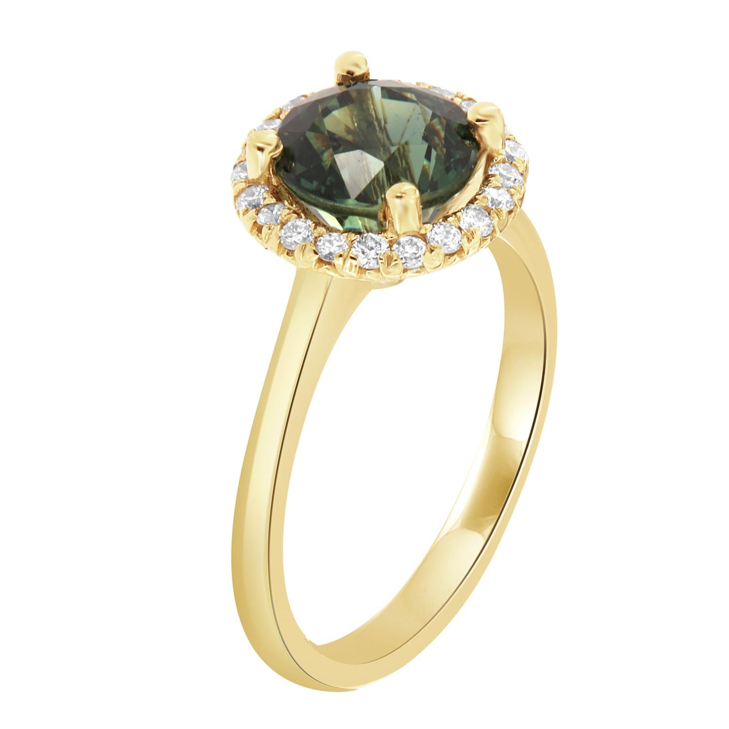 This 18k yellow gold ring features a rare none-heated GIA Certified 2.07 round-shaped Natural Sapphire in vibrant Teal color ( Greenish- Blue) with an excellent luster, encircled by a halo of brilliant round diamonds on a 1.8 mm wide band. 
The