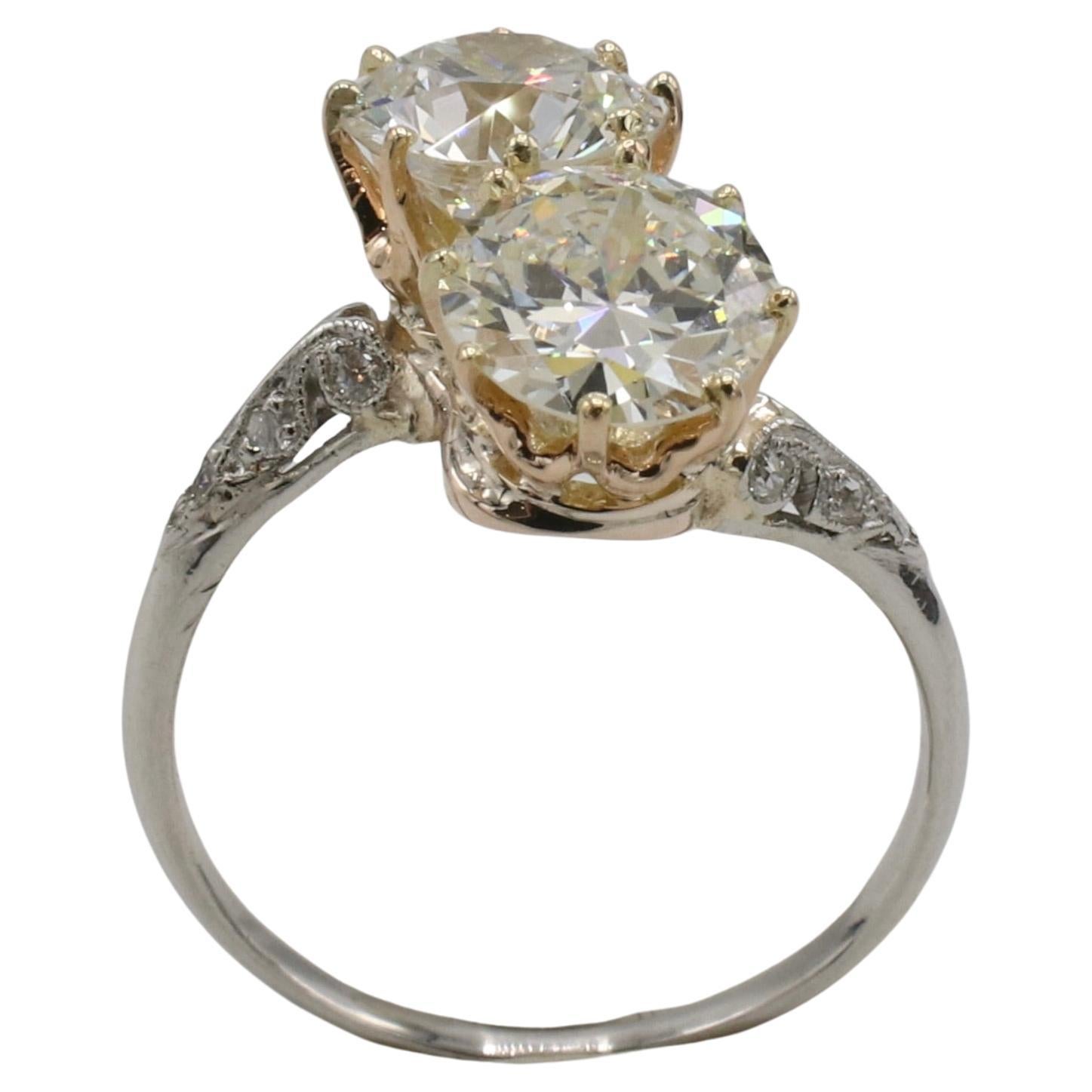 GIA Certified 2.08 Carat Natural Two-Diamond Toi et Moi Art Deco Ring 
Metal: 14k white/yellow gold
Weight: 2.94 grams
Diamonds: GIA certified 1.14 carat circular brilliant I SI2 & GIA certified .94 carat circular brilliant K VS1
GIA report numbers: