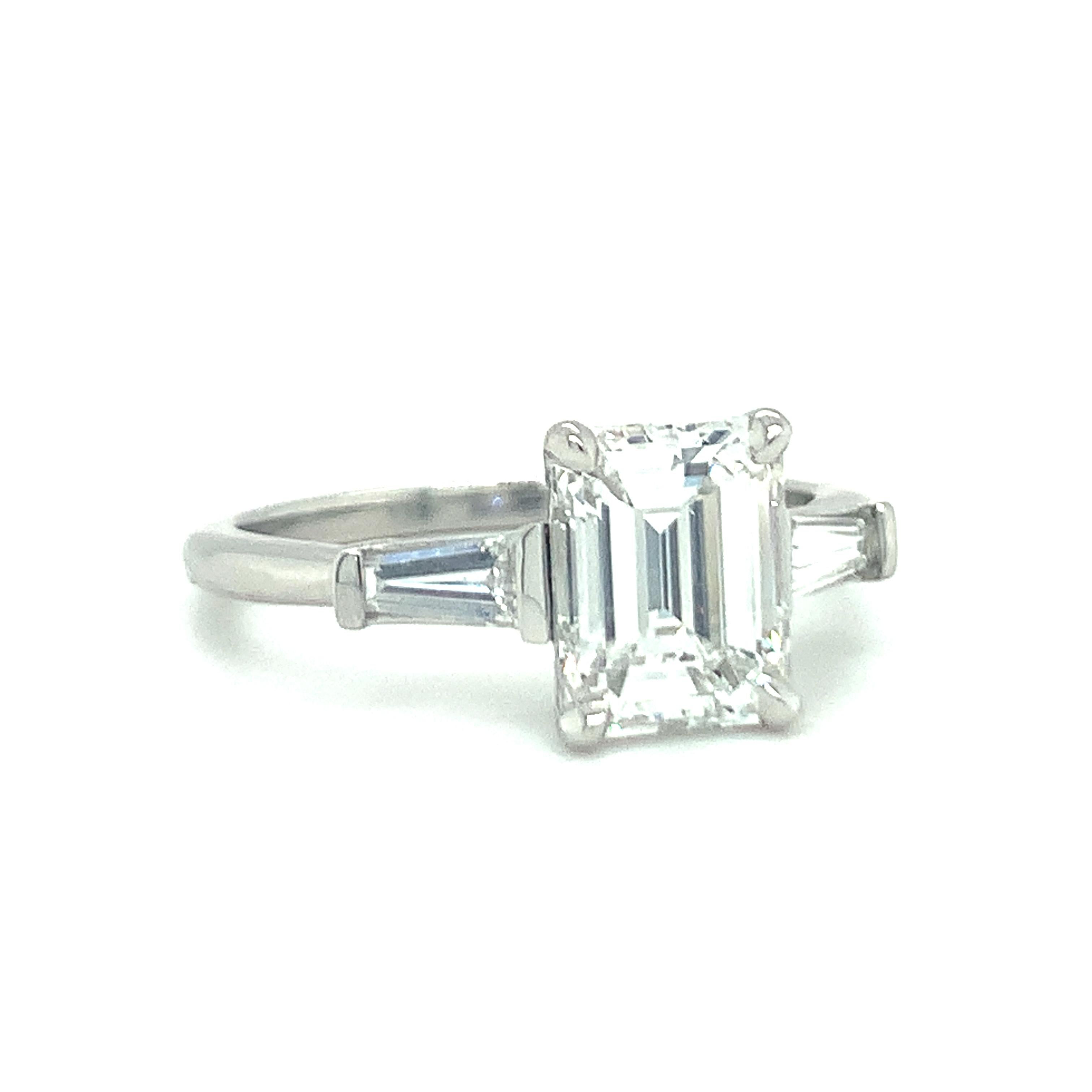 One GIA certified 2.09 ct. diamond platinum engagement ring centering one prong set, emerald cut diamond weighing 2.09 ct. with H color and VS-1 clarity. Flanked by two tapered baguette cut diamonds weighing 0.50 ct. total with G-H color and VS-1