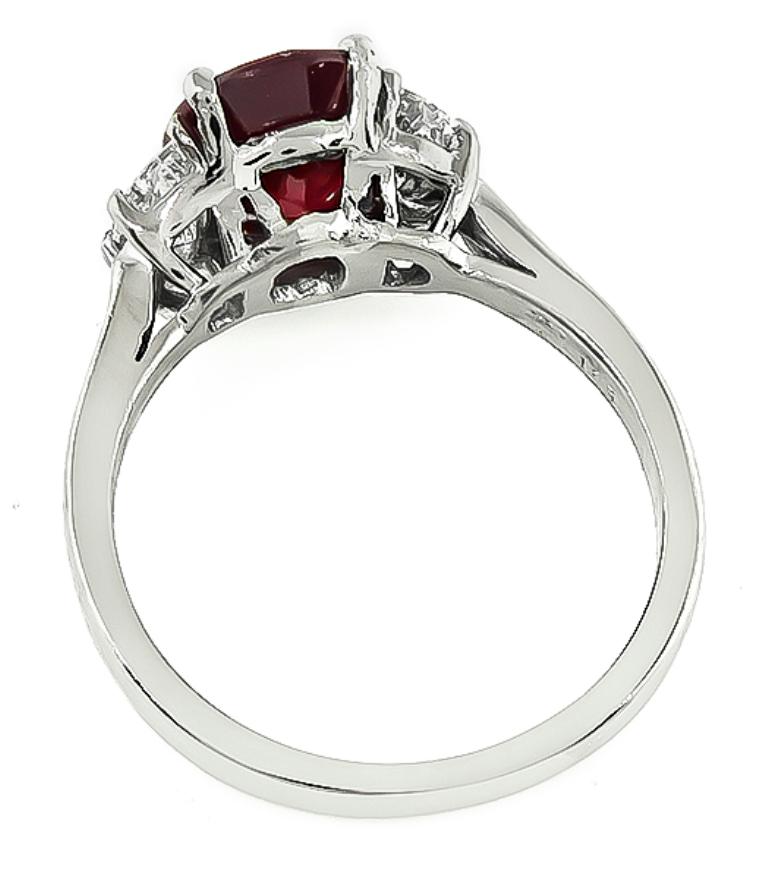 This elegant ring is centered with a lovely GIA certified oval cut ruby that weighs 2.09ct. The ruby is accentuated by sparkling faceted half moon cut diamonds that weigh approximately 0.70ct. graded G color with VS clarity. The top of the ring