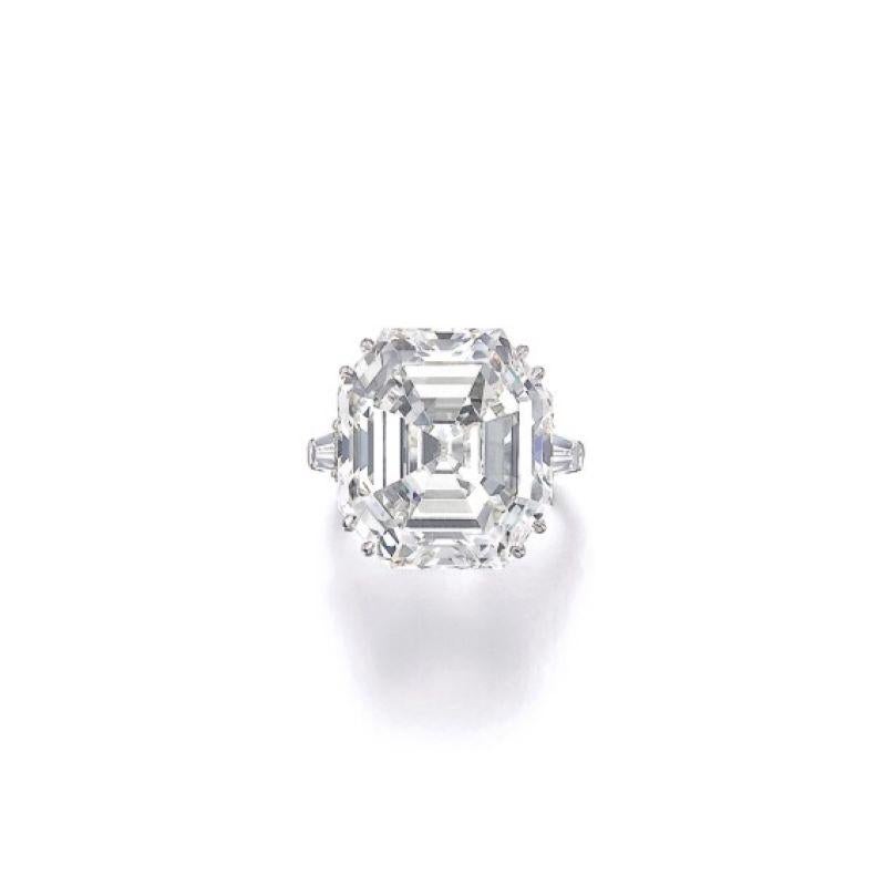 Rare and beautiful Antique Emerald Cut Diamond in a simple Ring with tapered baguette side stones.

21.71 Carat

Stone is certified by GIA
J Color and VVS2 Clarity
