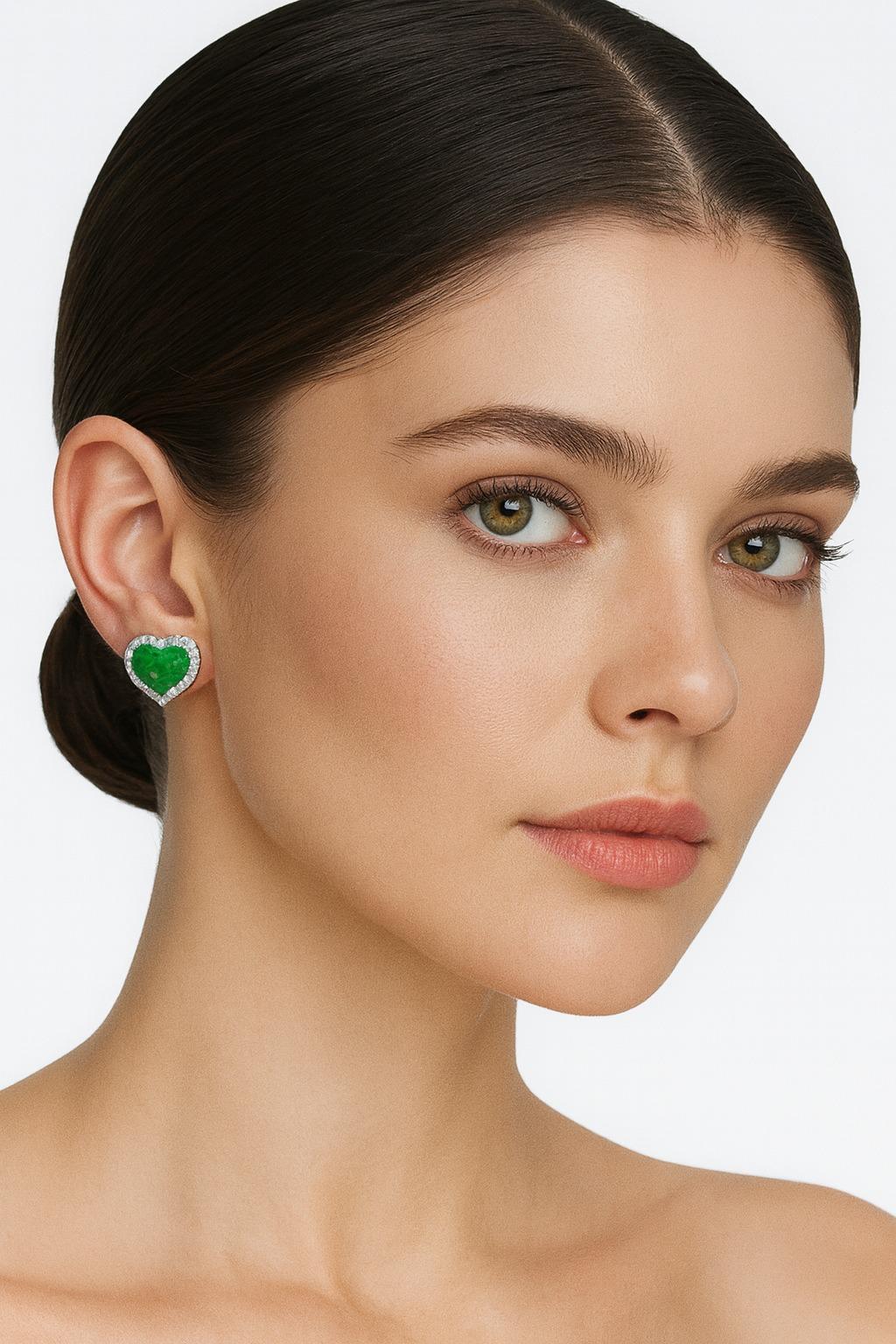 GIA Certified 21 Carat Total Heart Shape Emerald and Diamond Platinum Halo Earrings

Description:
A spectacular pair of earrings featuring two vivid green heart-shaped emeralds weighing a total of 20.90 carats, certified by GIA. Each emerald is