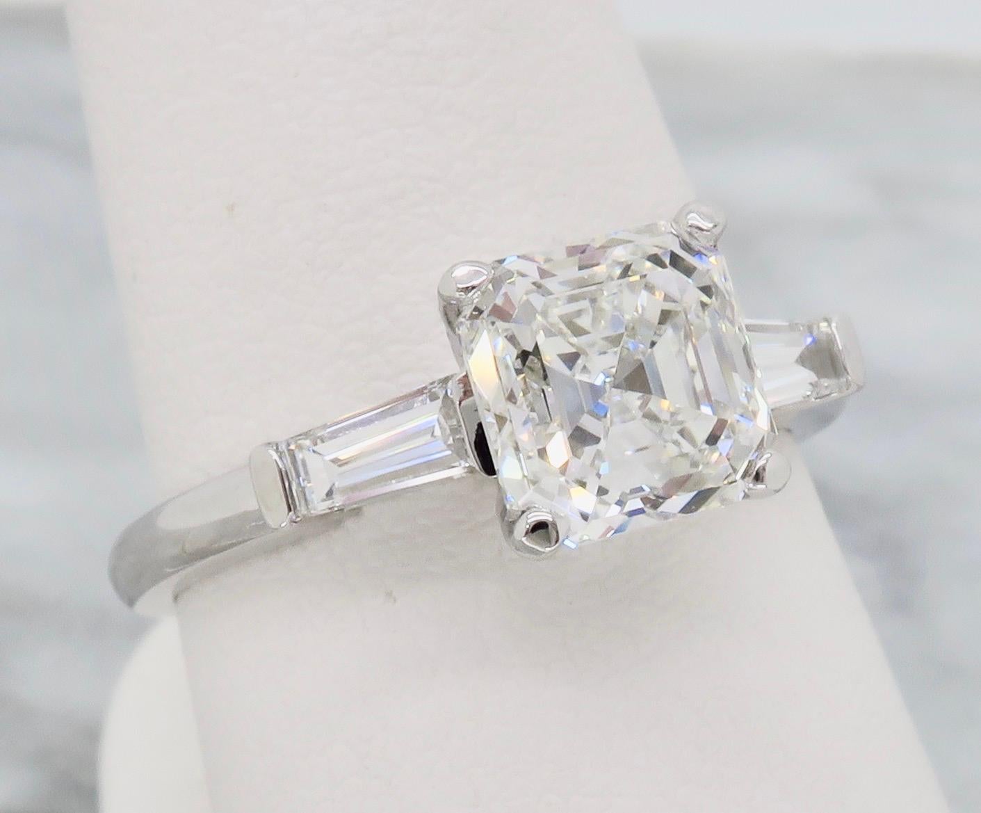 GIA Certified 1.80CT Square Emerald Cut Diamond with flanking tapered Baguette Cut diamonds crafted in 14k white gold.

GIA Certified #16297054
Center Diamond Carat Weight: 1.80CT
Center Diamond Cut: Square Emerald Cut
Center Diamond Color: F
Center