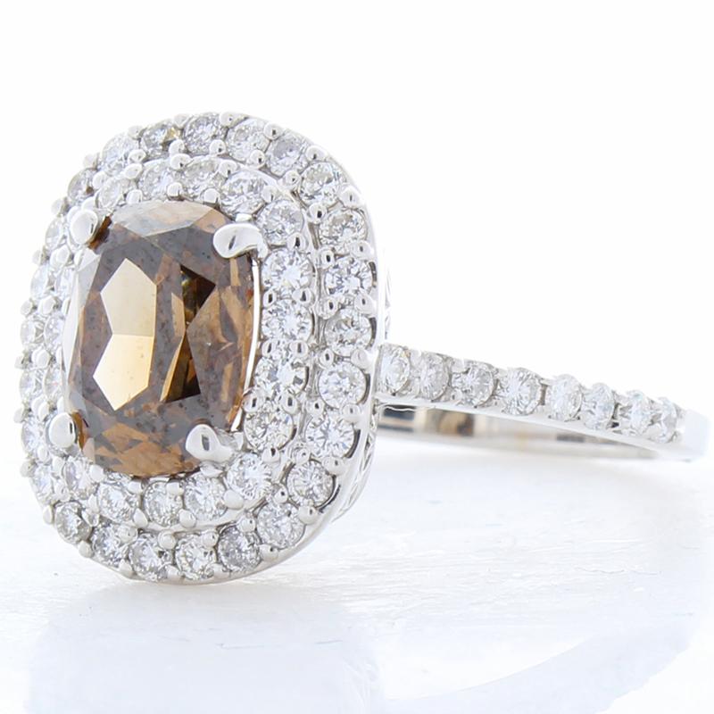 This natural cognac diamond exceptionally stunning. The ring features a lavish 2.11 carat natural fancy dark orangy brown cushion-cut diamond. It is GIA certified. Its luster and transparency is excellent; its intense color is evenly distributed