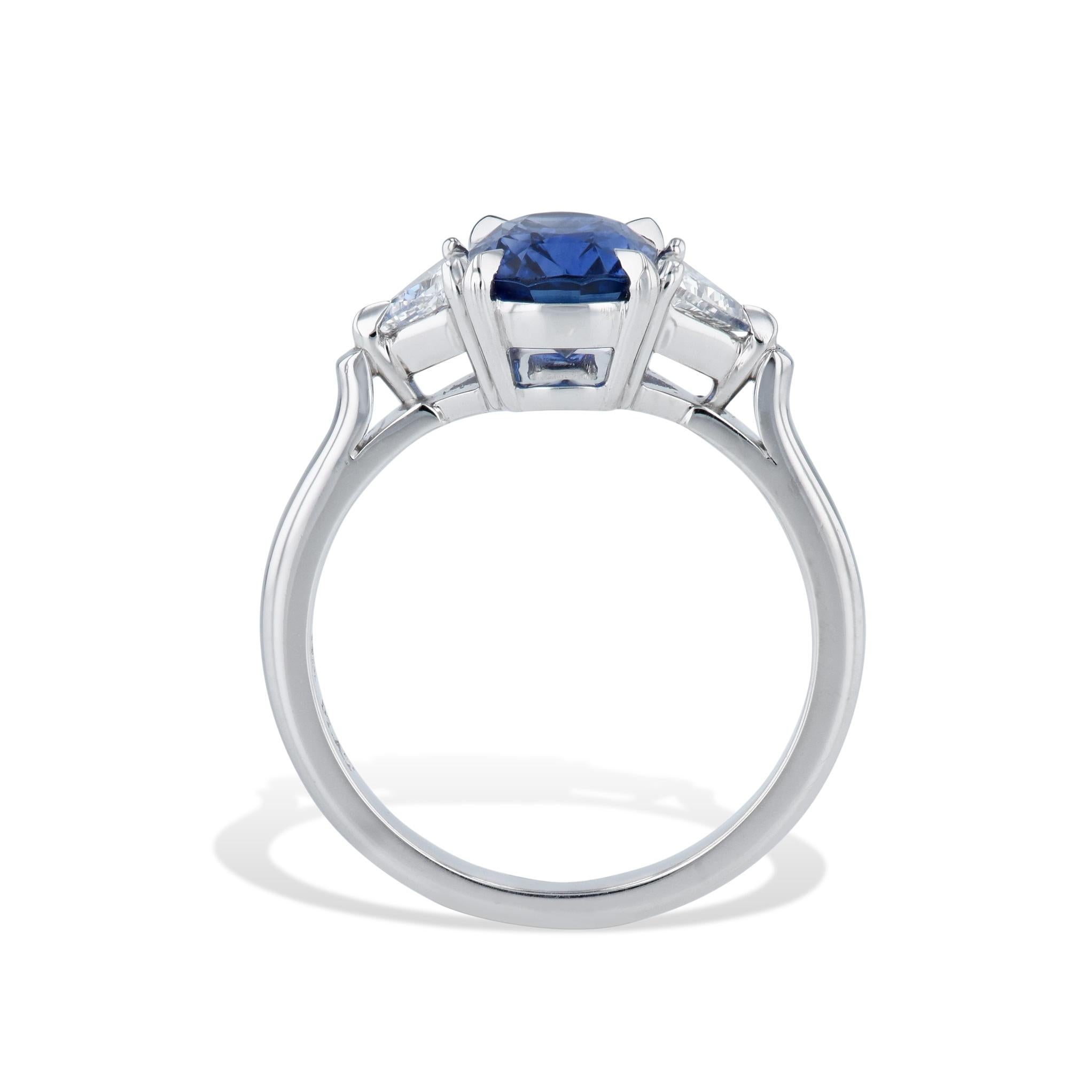 Awe-inspiring Madagascar Blue Sapphire Diamond Trillion Platinum Ring! 
Be mesmerized by a dazzling cushion cut Madagascar Blue Sapphire at the heart of this handmade HH Collection masterpiece. 
Complimented by Trillion Cut diamonds on either side,