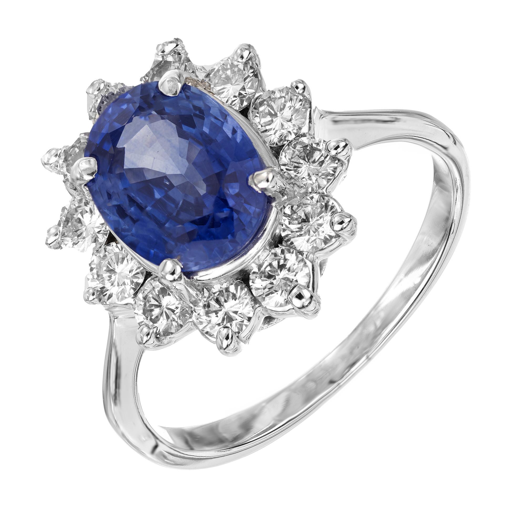This stunning oval 2.11ct sapphire is mounted in a 14k white gold setting. Accented by a halo of 12 round brilliant diamonds. The GIA has certified the sapphire as natural, with simply heat. Classic style and design. 

1 oval blue sapphire, approx.