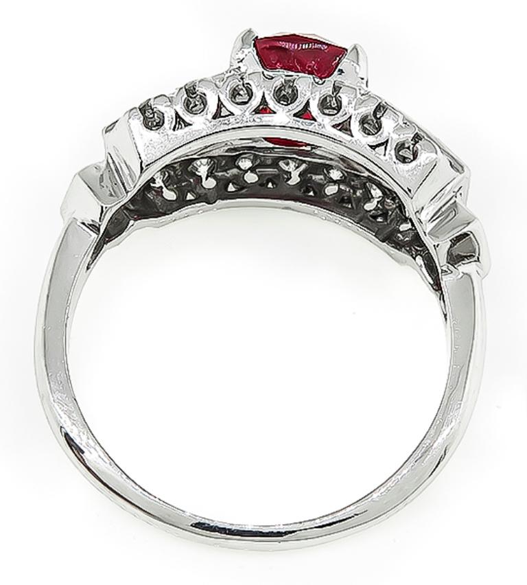 This amazing 14k white gold engagement ring is centered with a lovely GIA certified oval cut ruby that weighs 2.11ct. The ruby is accentuated by sparkling baguette and round cut diamonds that weigh approximately 1.00ct. graded G color with VS
