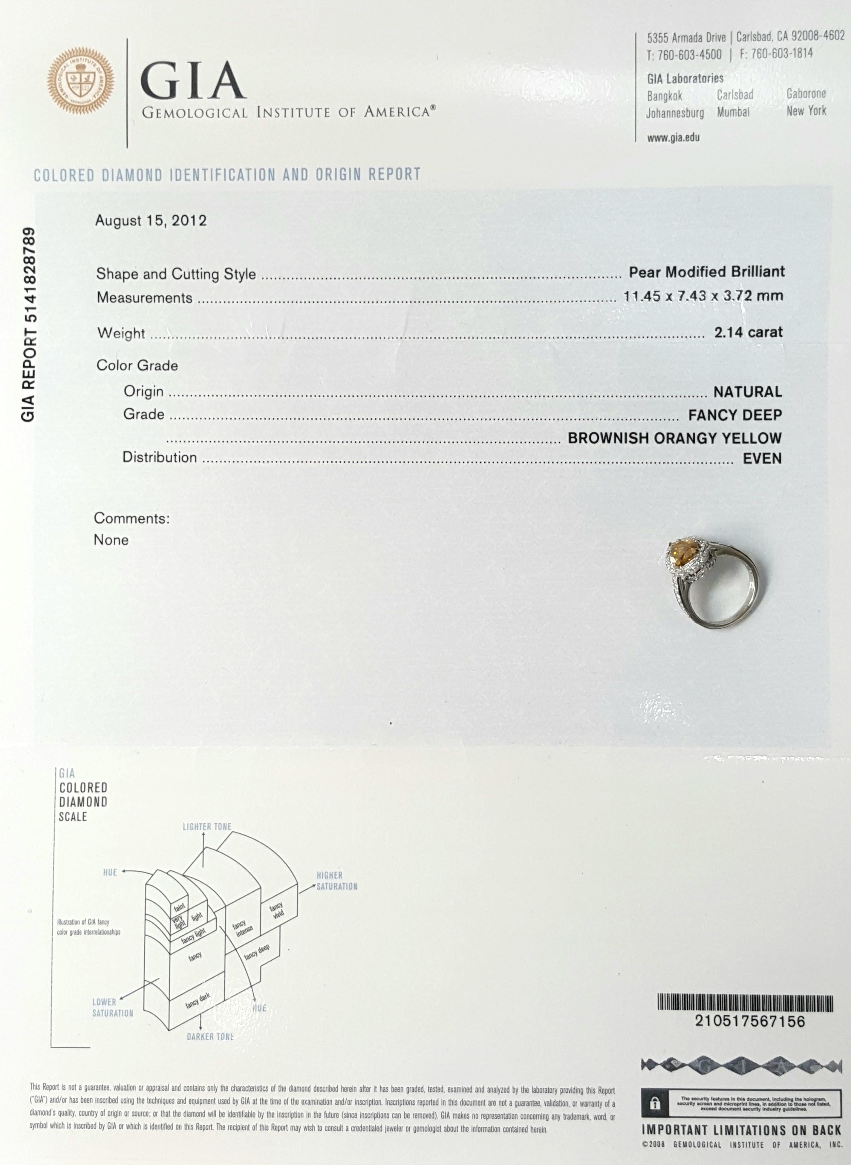 This GIA certified 2.12 Carat Fancy Yellow Diamond is set in Platinum with accenting diamond set on the halo and down the sides.The gallery on the sides is detailed with minimal swirl designs alongside a touch of milgrain giving it a vintage twist